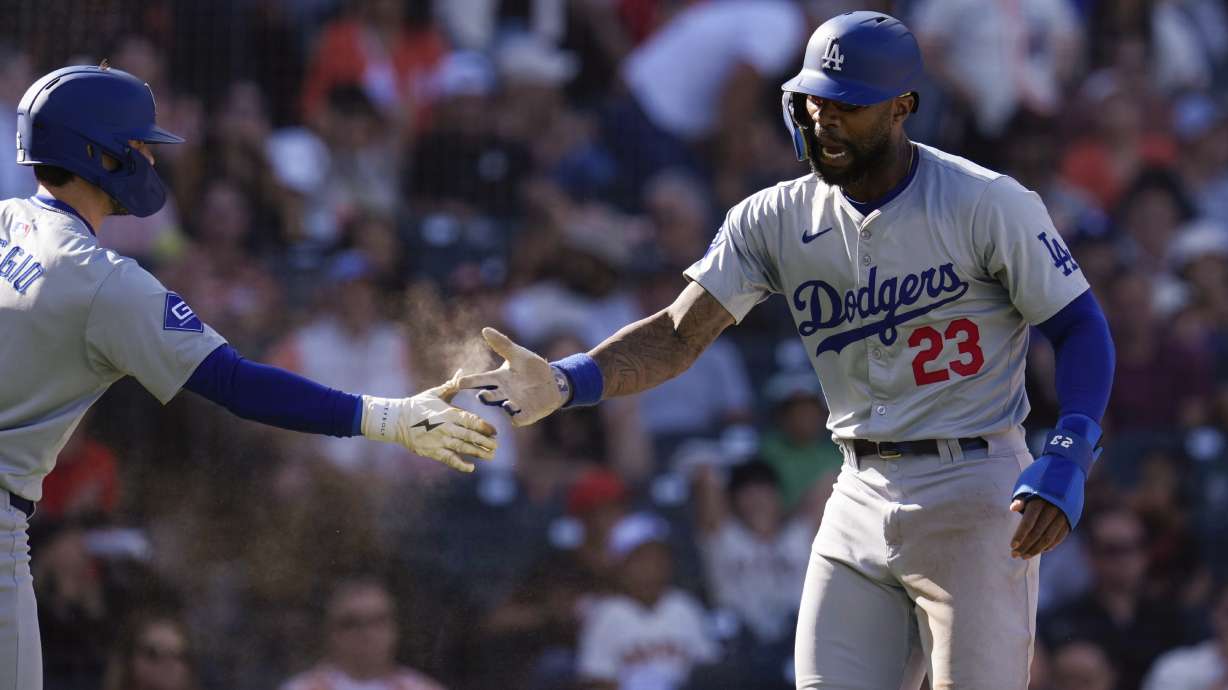 Los Angeles Dodgers' Jason Heyward, right, celebrates with Cavan Biggio after scoring against the San Francisco Giants on Gavin Lux's single during the fourth inning of a baseball game Saturday, June 29, 2024, in San Francisco.