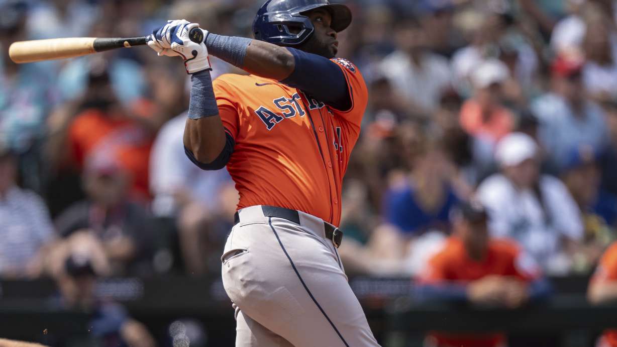 Houston Astros' Yordan Alvarez hits a one-run triple during the sixth inning of a baseball game against the Seattle Mariners, Sunday, July 21, 2024, in Seattle.