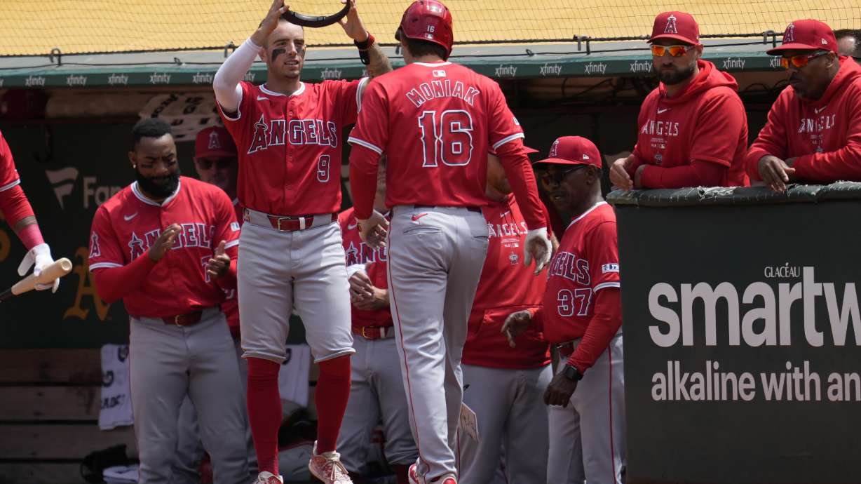 Los Angeles Angels' Mickey Moniak (16) is congratulated by Zach Neto (9) after hitting a home run during the fifth inning of a baseball game against the Oakland Athletics in Oakland, Calif., Sunday, July 21, 2024.