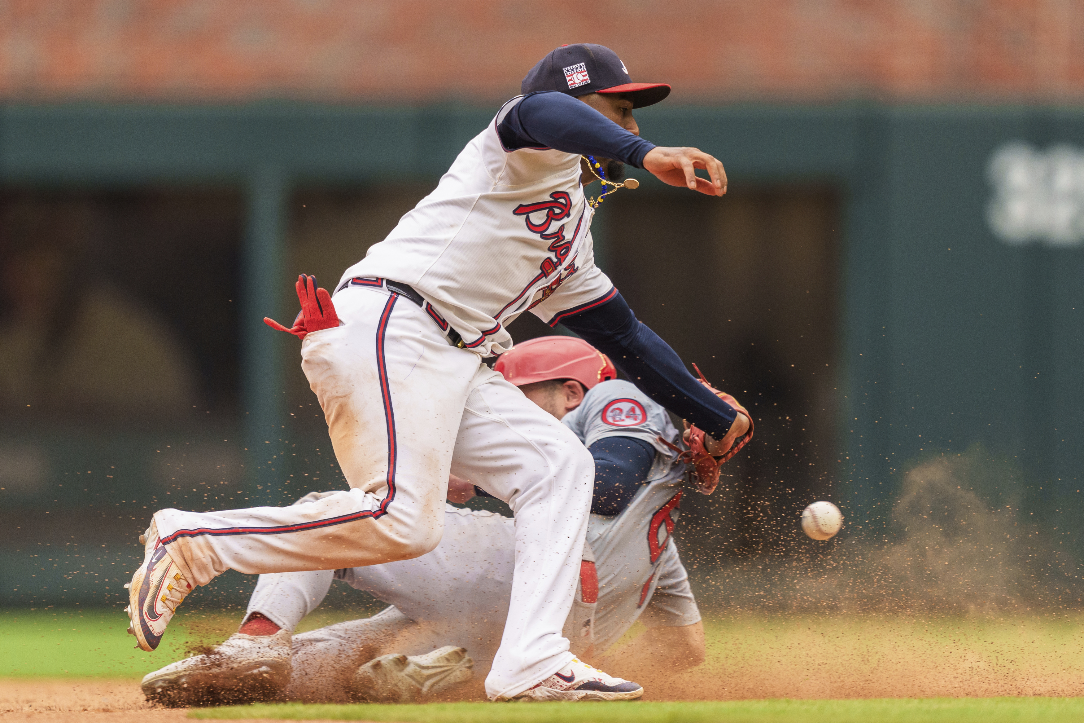 Atlanta Braves second baseman Ozzie Albies, top, attempts to tag out St. Louis Cardinals Michael Siani, bottom, in the eighth inning of a baseball game, Sunday, July 21, 2024, in Atlanta.