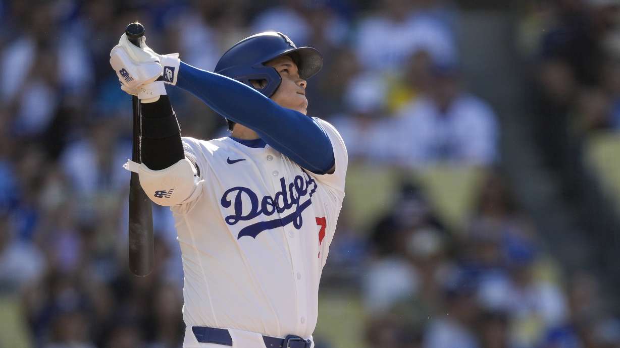 Los Angeles Dodgers designated hitter Shohei Ohtani watches his solo home run during the fifth inning of a baseball game against the Boston Red Sox, Sunday, July 21, 2024, in Los Angeles.