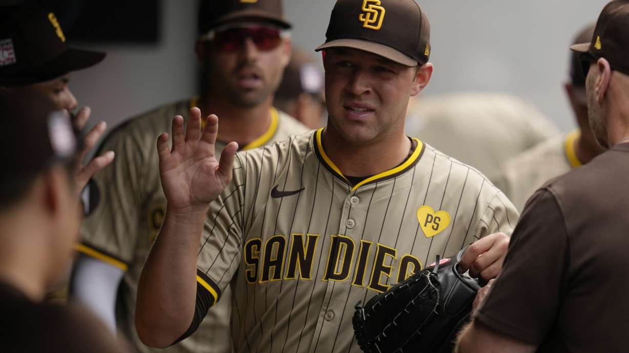 San Diego Padres pitcher Michael King is greeted in the dugout after the seventh inning of a baseball game against the Cleveland Guardians, Sunday, July 21, 2024, in Cleveland.