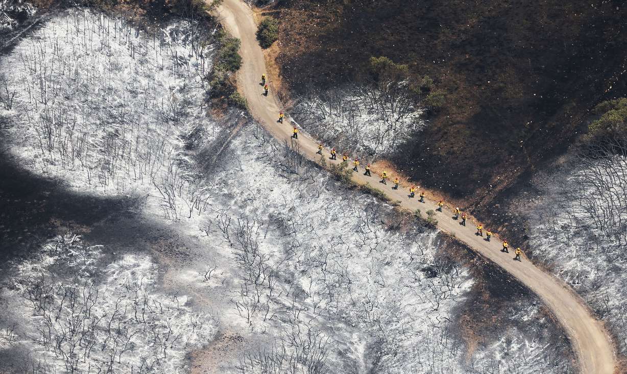 Firefighters walk through the Sandhurst Fire near Ensign Peak in Salt Lake City on Sunday.
