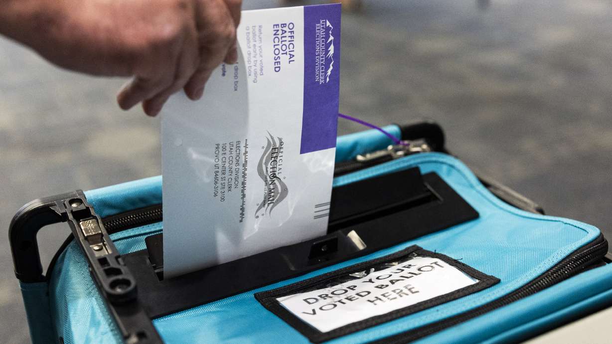 A voter submits their ballot during primary election voting in Provo on June 25. Lt. Gov. Deidre Henderson certified Utah's primary election results Monday, solidifying wins for Gov. Spencer Cox and Rep. Celeste Maloy.