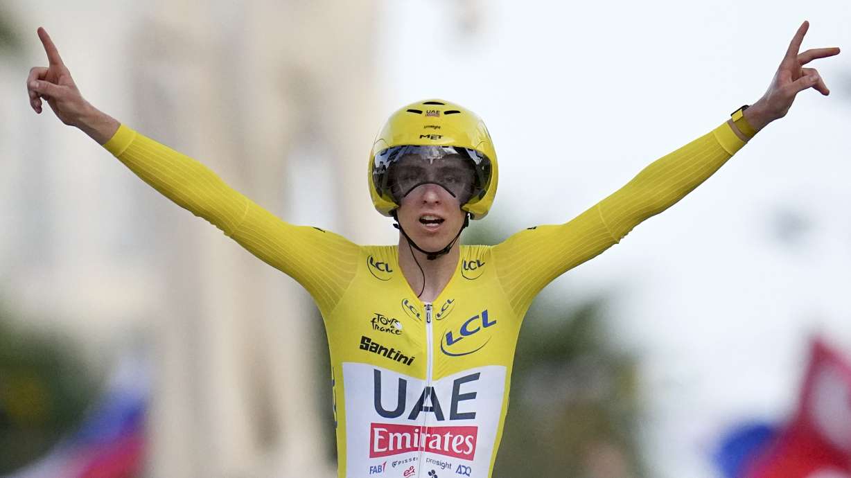 Tour de France winner Slovenia's Tadej Pogacar celebrates as he crosses the finish line to win the twenty-first stage of the Tour de France cycling race, an individual time trial over 33.7 kilometers (20.9 miles) with start in Monaco and finish in Nice, France, Sunday, July 21, 2024.