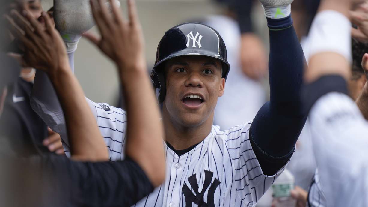 New York Yankees' Juan Soto celebrates his solo home run in the dugout during the seventh inning of a baseball game against the Tampa Bay Rays at Yankee Stadium Monday, July 22, 2024, in New York.