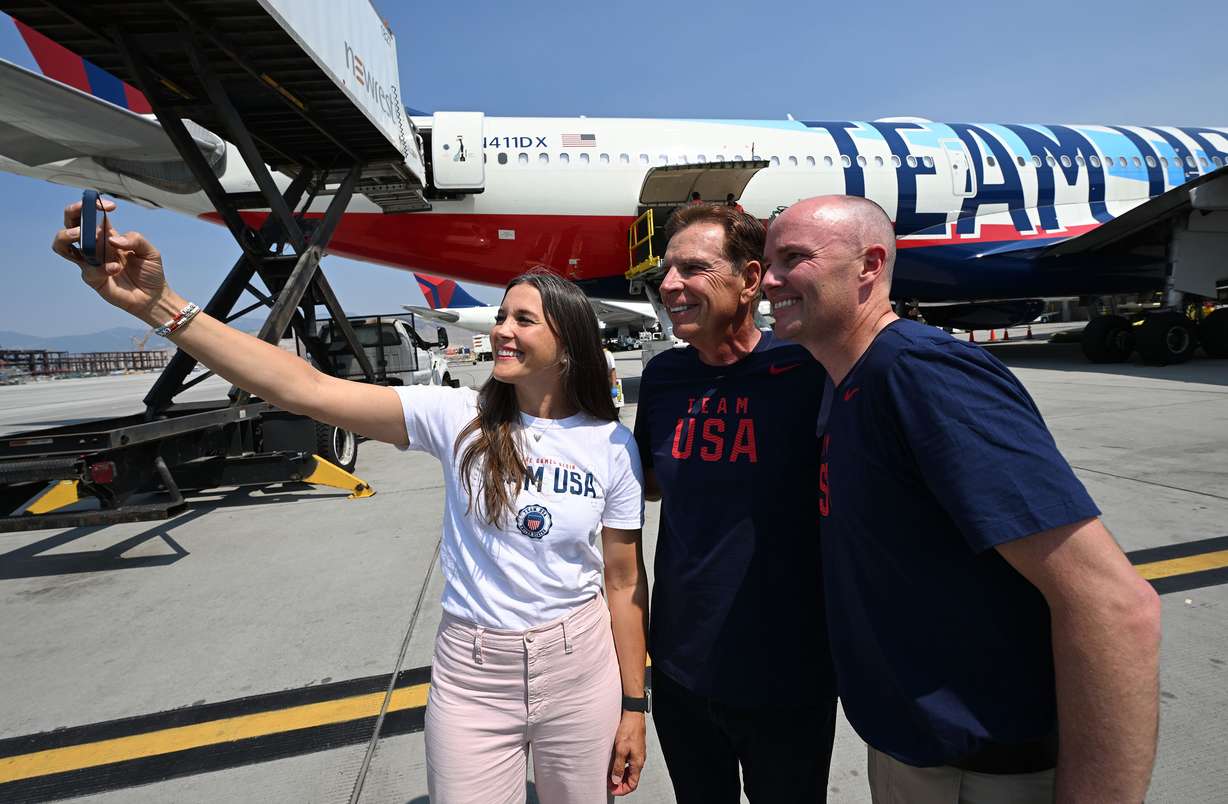 Gov. Spencer Cox, Salt Lake City Mayor Erin Mendenhall, and SLC-UT 2034 President and CEO Fraser Bullock take a selfie near the plane as Utah’s Olympic delegation boards Delta Flight 2034 bound for Paris at the Salt Lake International Airport on Monday, July 22, 2024.