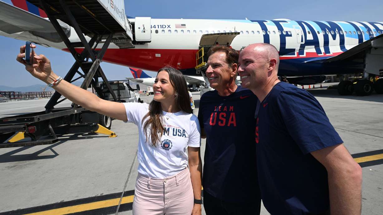 Salt Lake City Mayor Erin Mendenhall, Fraser Bullock and Gov. Spencer Cox take a selfie near the plane as Utah’s Olympic delegation boards Delta Flight 2034 bound for Paris at the Salt Lake City International Airport on Monday.
