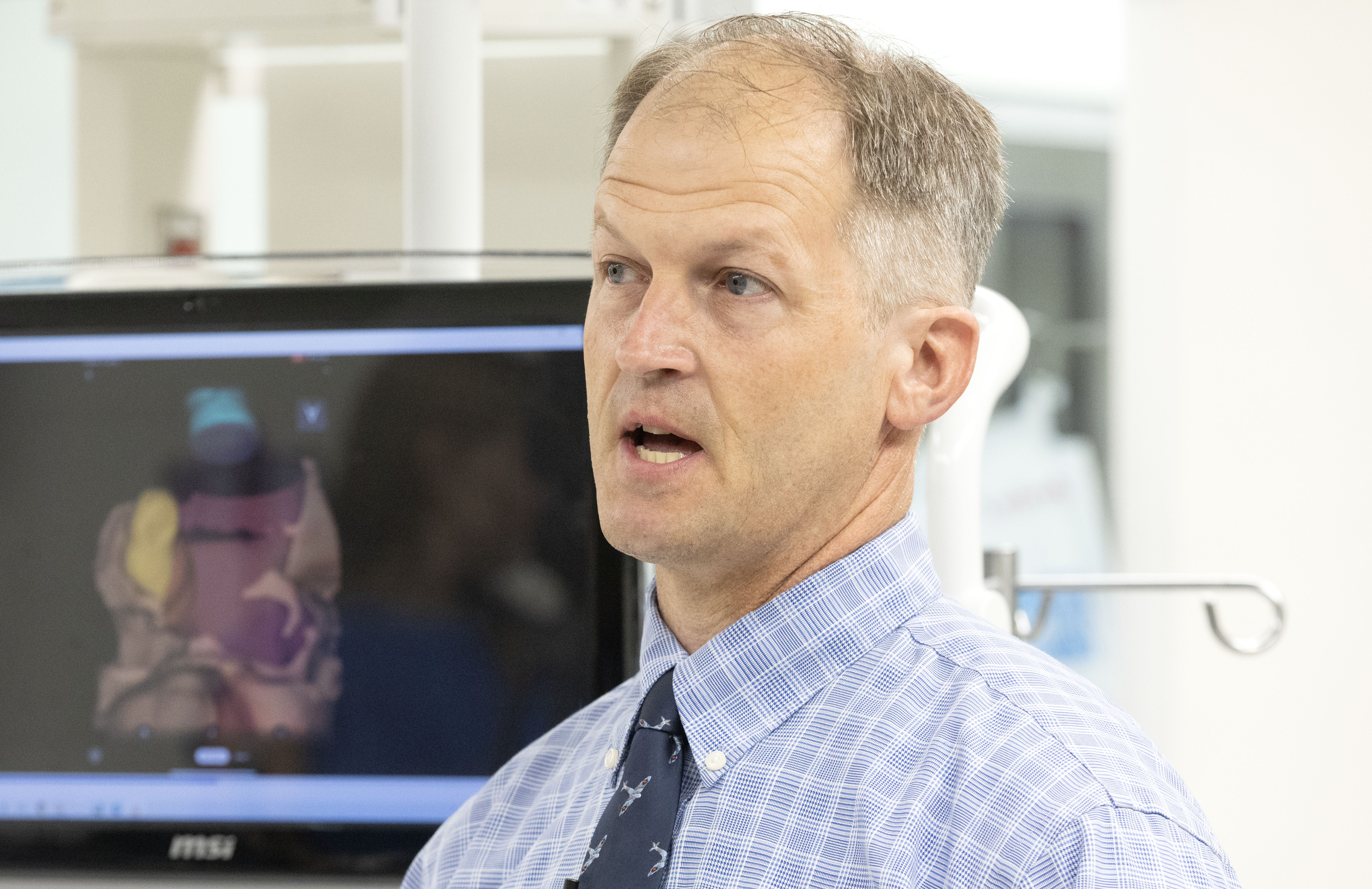 Tom Evans, a 50-year-old school teacher from Riverton, talks to media about the new technology that helped Dr. Tae Kim operate on him during his recent surgery at a press conference on Monday