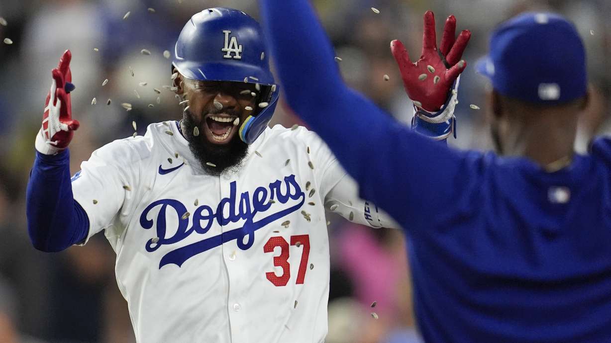 Los Angeles Dodgers' Teoscar Hernández, left, has sunflower seeds tossed at him after his solo home run during the fourth inning of a baseball game against the San Francisco Giants, Monday, July 22, 2024, in Los Angeles.