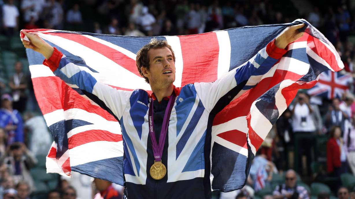 FILE - Gold medalist Andy Murray of Great Britain waves the British flag during the medal ceremony of the men's singles event at the All England Lawn Tennis Club at Wimbledon, in London, at the 2012 Summer Olympics, Sunday, Aug. 5, 2012.