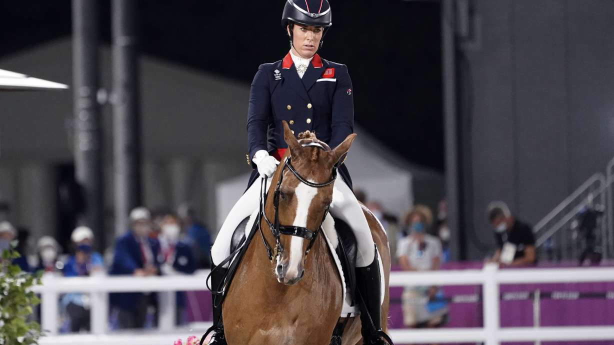 FILE - Britain's Charlotte Dujardin, riding Gio, competes in the equestrian dressage individual final at the 2020 Summer Olympics, Wednesday, July 28, 2021, in Tokyo. Three-time Olympic gold medalist Charlotte Dujardin of Great Britain has withdrawn from the Paris Games after a video emerged that she says shows her behaving inappropriately while coaching other riders.