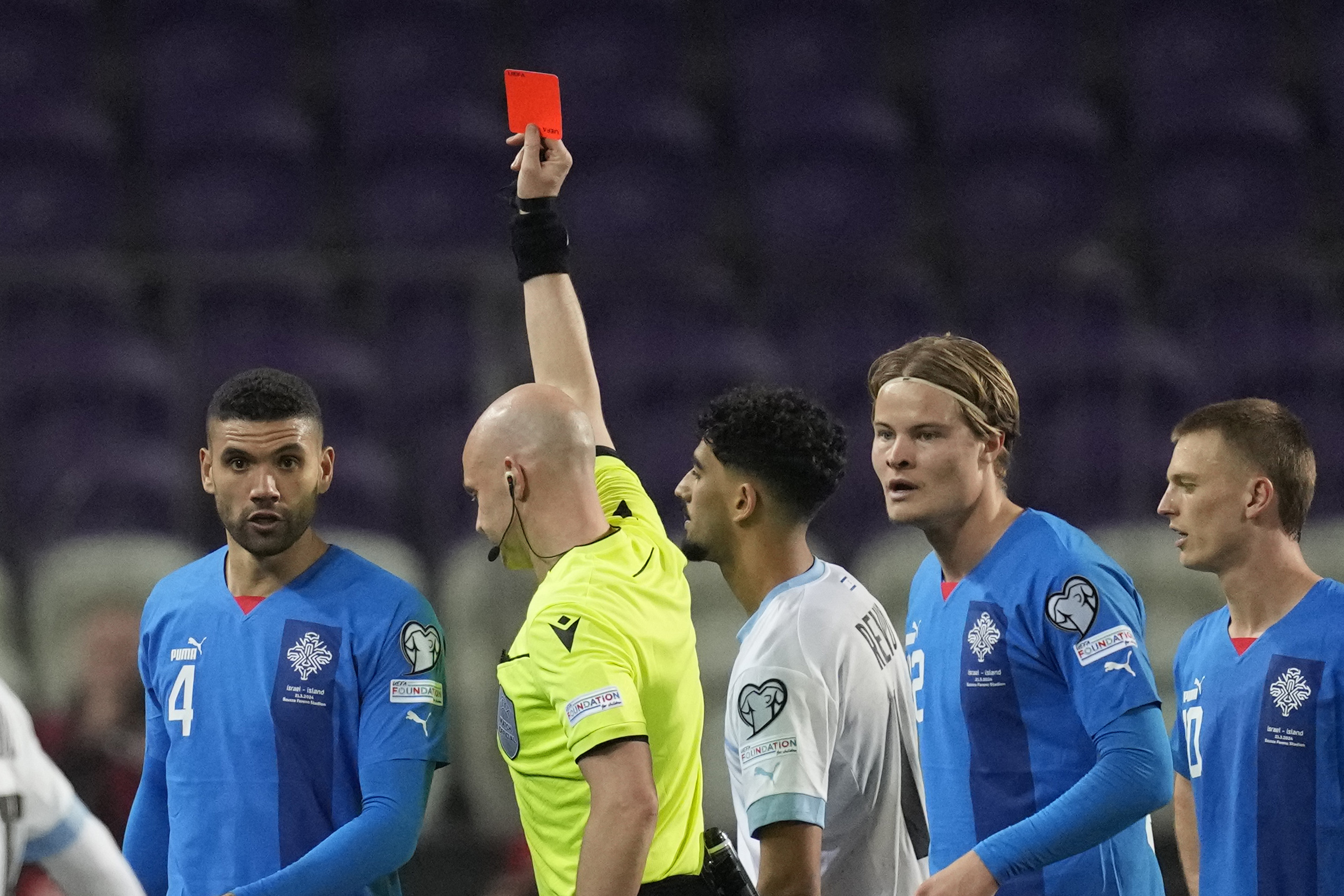 FILE - Israel's Roy Revivo receives a red card by referee Anthony Taylor during the Euro 2024 qualifying play-off soccer match between Israel and Iceland, at Szusza Ferenc Stadium in Budapest, Hungary, Thursday, March 21, 2024. The Olympic debut of Israel soccer player Roy Revivo on Wednesday, July 24, 2024 is on doubt until a sports court hearing in Paris hours before the game against Mali decides if he is banned.