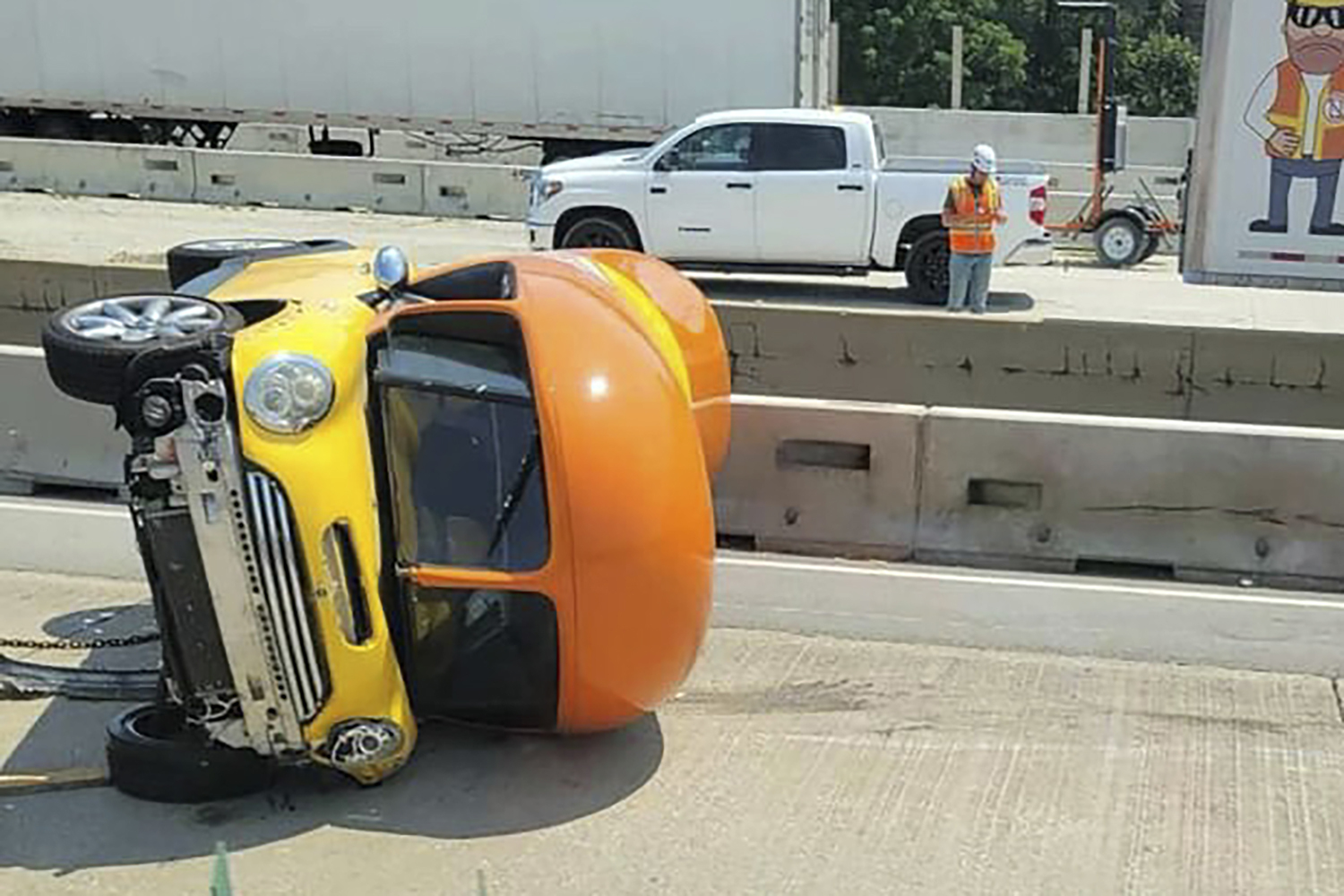 One of Oscar Mayer’s hot dog-shaped Wienermobiles is flipped onto its side after crashing along Interstate 294, a suburban Chicago highway, Monday in Oak Brook, Ill. 