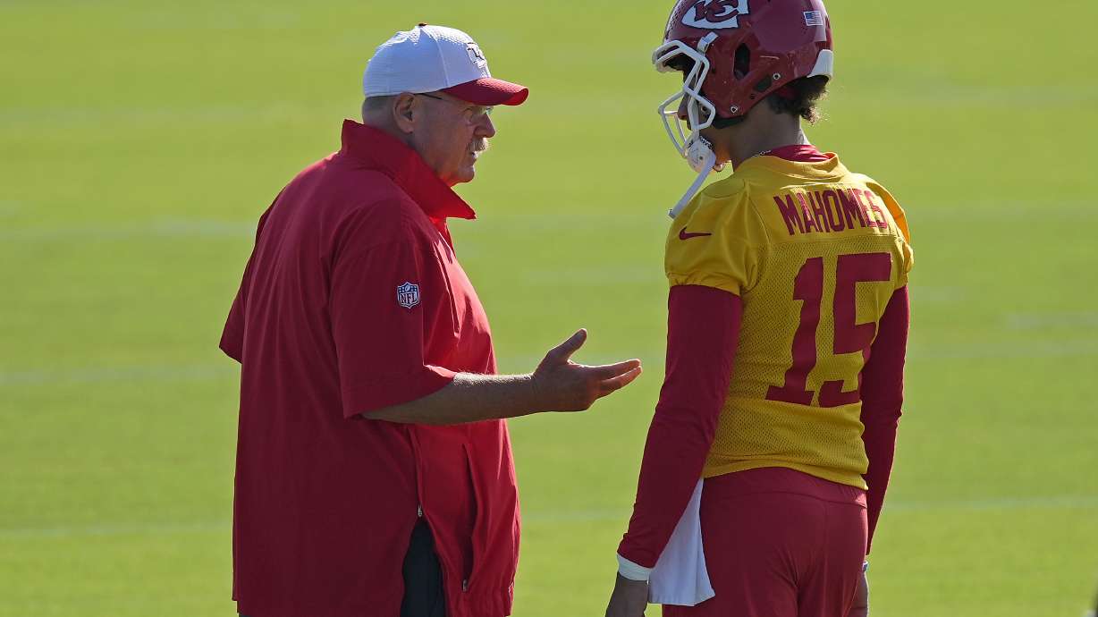 Kansas City Chiefs head coach Andy Reid talks to quarterback Patrick Mahomes (15) during NFL football training camp Thursday, July 18, 2024, in St. Joseph, Mo.