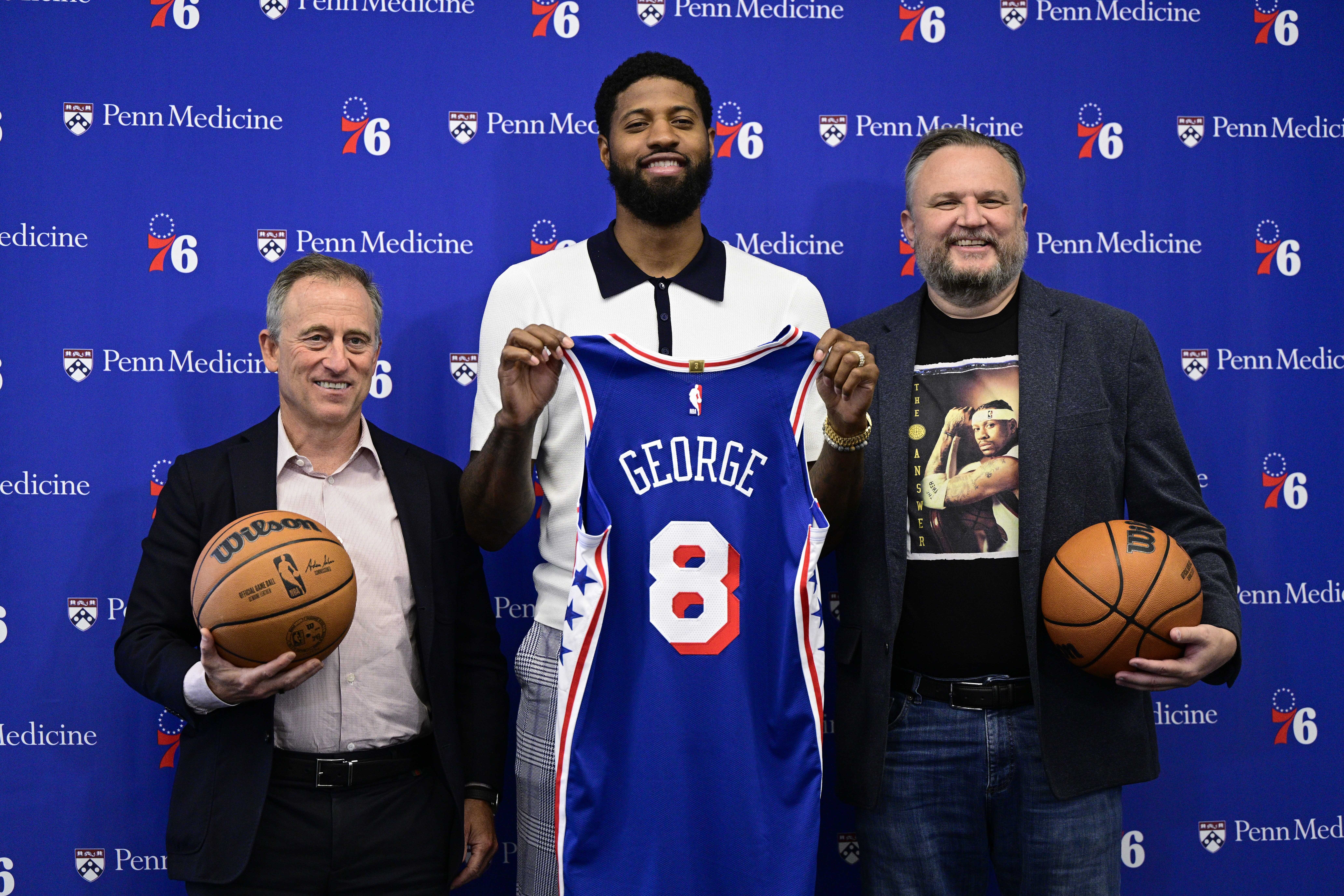 Philadelphia 76ers' Paul George center, owner Josh Harris, left, and president Daryl Morey pose for a photo at the NBA basketball team's practice facility, Tuesday, July 23, 2024, in Camden, N.J.