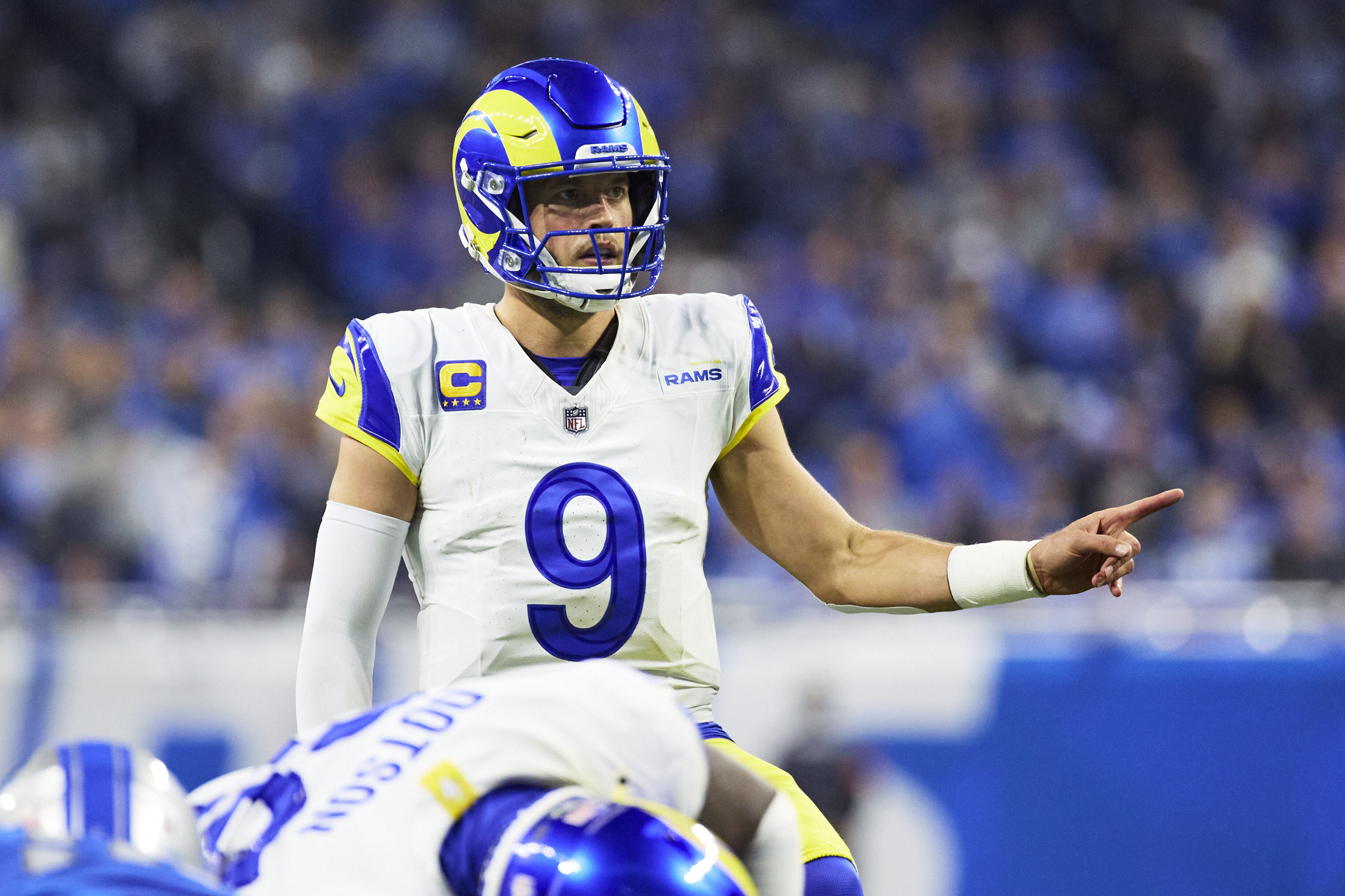 FILE - Los Angeles Rams quarterback Matthew Stafford gets set to run a play against the Detroit Lions during an NFL wild-card playoff football game, Jan. 14, 2024, in Detroit. The Rams have come to a resolution with Stafford to avoid a potential holdout during training camp, which starts Wednesday, July 24 at Loyola Marymount University.