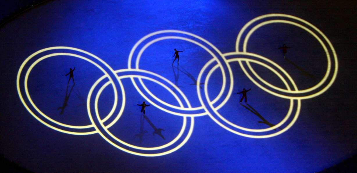 Skaters pose in the Olympic Rings on the ice during the Opening Ceremonies of the Salt Lake 2002 Winter Olympic Games at Rice-Eccles Stadium Friday, Feb. 8, 2002.