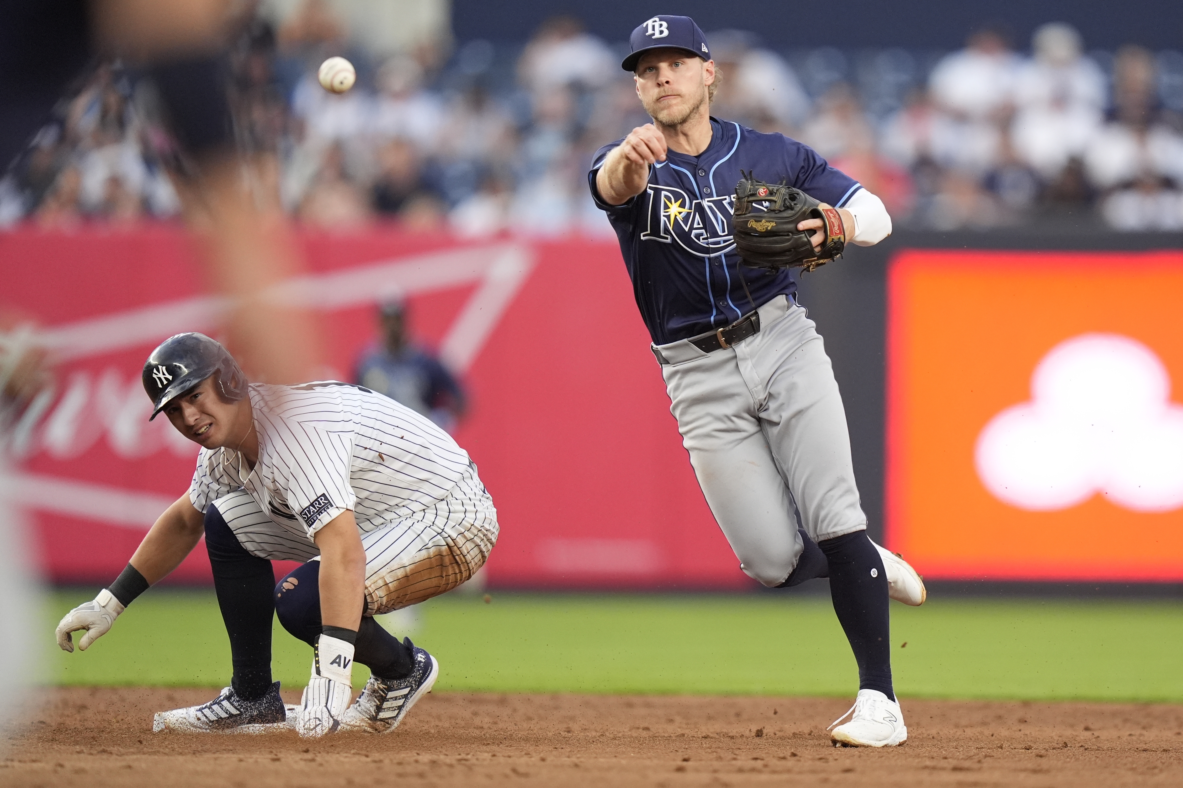 Tampa Bay Rays' Taylor Walls throws out New York Yankees' DJ LeMahieu at first base after forcing out New York Yankees' Anthony Volpe, left, during the second inning of a baseball game, Friday, July 19, 2024, in New York.