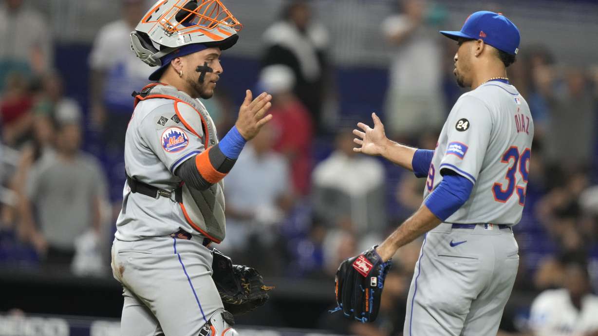 New York Mets catcher Francisco Alvarez, left, and relief pitcher Edwin Diaz (39) shake hands after a baseball game against the Miami Marlins, Monday, July 22, 2024, in Miami.