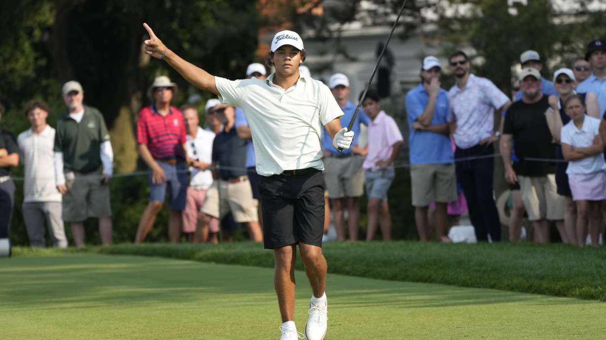 Charlie Woods signals after hitting off the 18th tee during the second round of stroke play of the U.S. Junior Amateur Golf Championship, Tuesday, July 23, 2024, in Bloomfield Township, Mich.