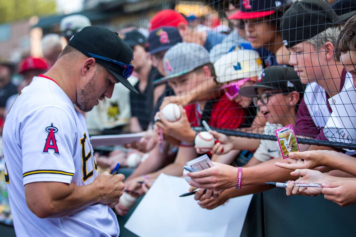 Los Angeles Angels outfielder Mike Trout signs autographs for fans before the Salt Lake Bees game at Smith's Ballpark in Salt Lake City on July 23. Trout made a one-game rehab stint with the team before reaggravating a knee injury.