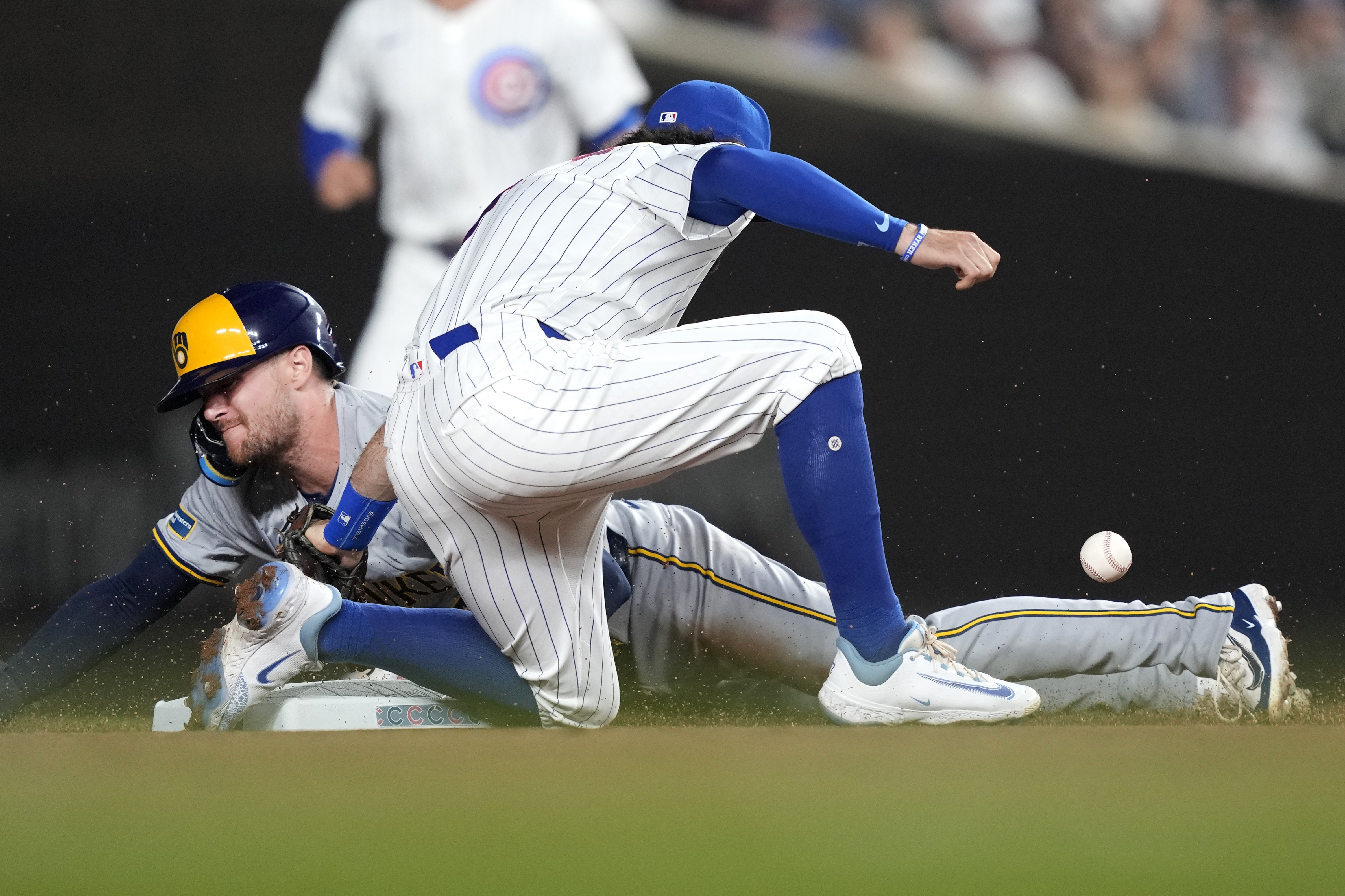 Milwaukee Brewers' Brice Turang steals second as Chicago Cubs' Dansby Swanson is unable to handle a throw from catcher Miguel Amaya during the first inning of a baseball game, Tuesday, July 23, 2024, in Chicago. 
