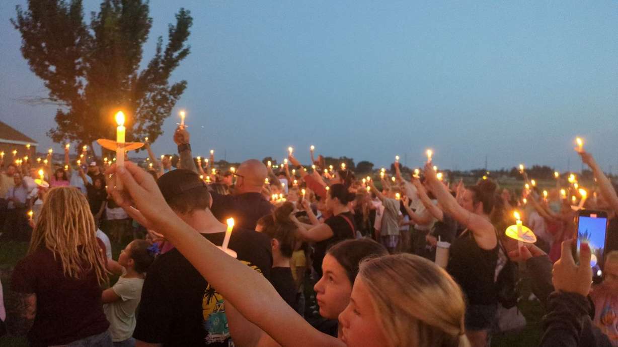 People hold candles Tuesday night in West Haven at the vigil for Gavin Peterson, a 12-year-old boy who died after years of suspected neglect and abuse.