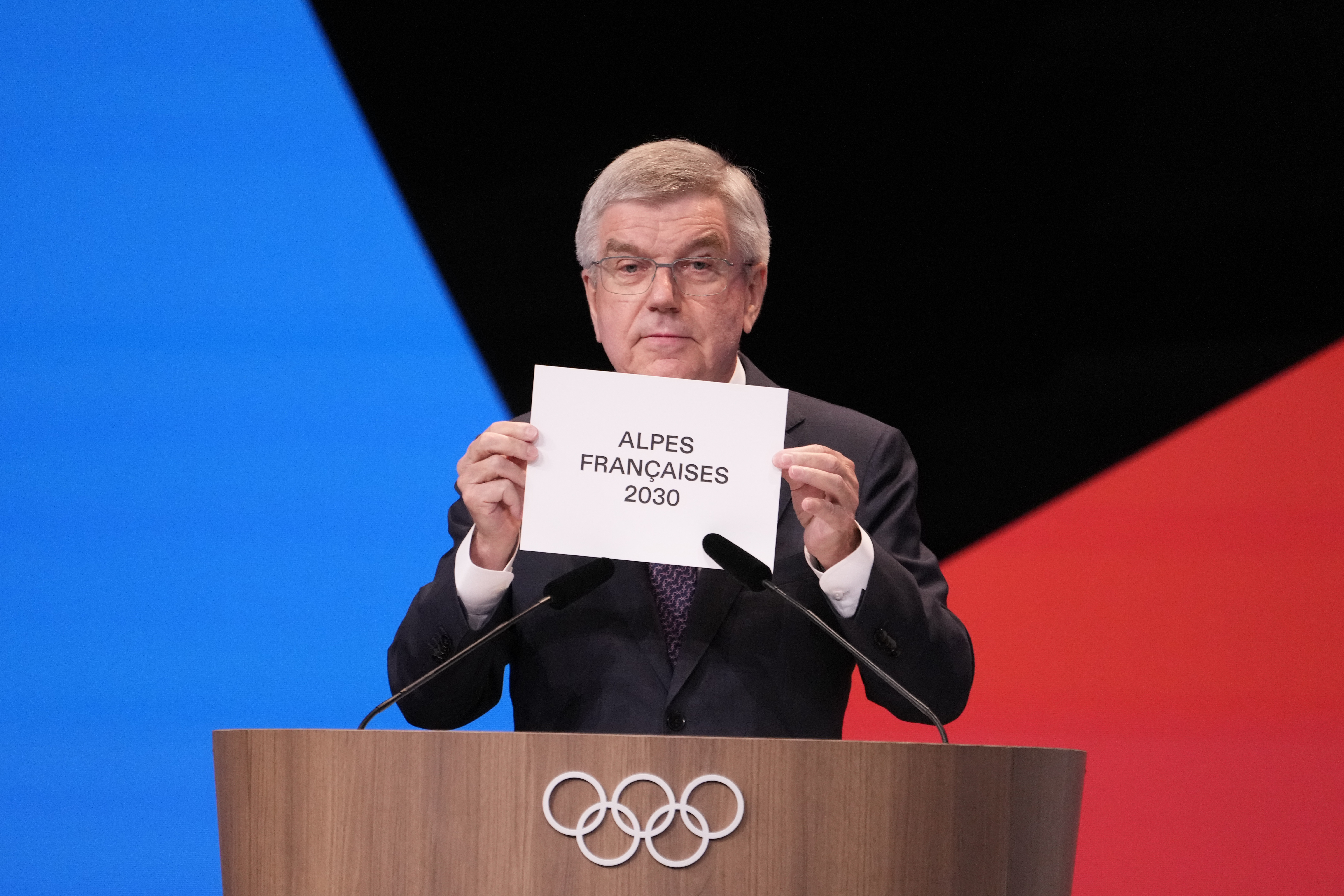 IOC president Thomas Bach announces that the French Alps was named as the 2030 Winter Games host at the 2024 Summer Olympics, Wednesday, July 24, 2024, in Paris, France. The French Alps was named as the 2030 Winter Games host by the International Olympic committee on Wednesday, though with conditions attached. 