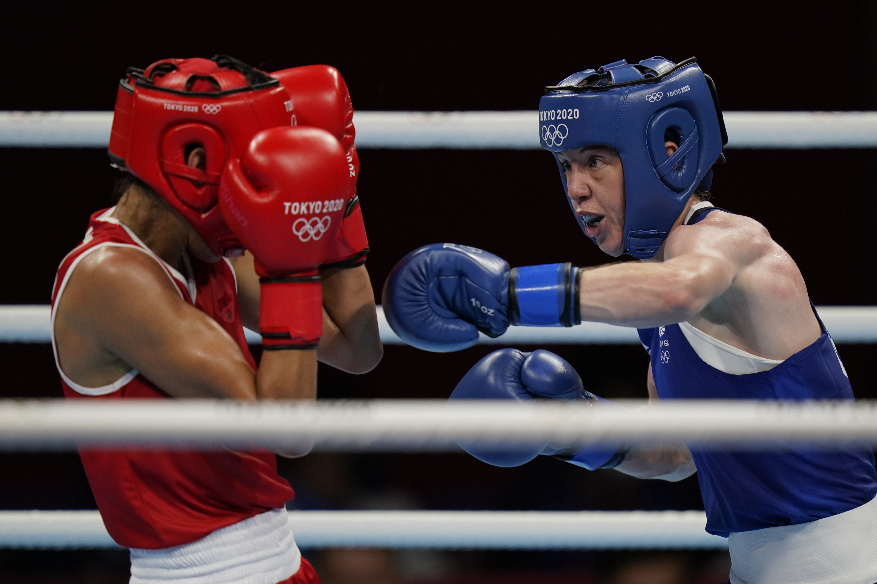 FILE - Morrocco's Rabab Cheddar, left, exchanges punches with Britains' Charley-Sian Davison during their women's flyweight 51-kg boxing match at the 2020 Summer Olympics, Sunday, July 25, 2021, in Tokyo, Japan. Just 12 years after women’s boxing debuted at the Olympics in only three weight classes, half of the boxers in Paris will be women in a field that’s deeper and more talented than ever. 