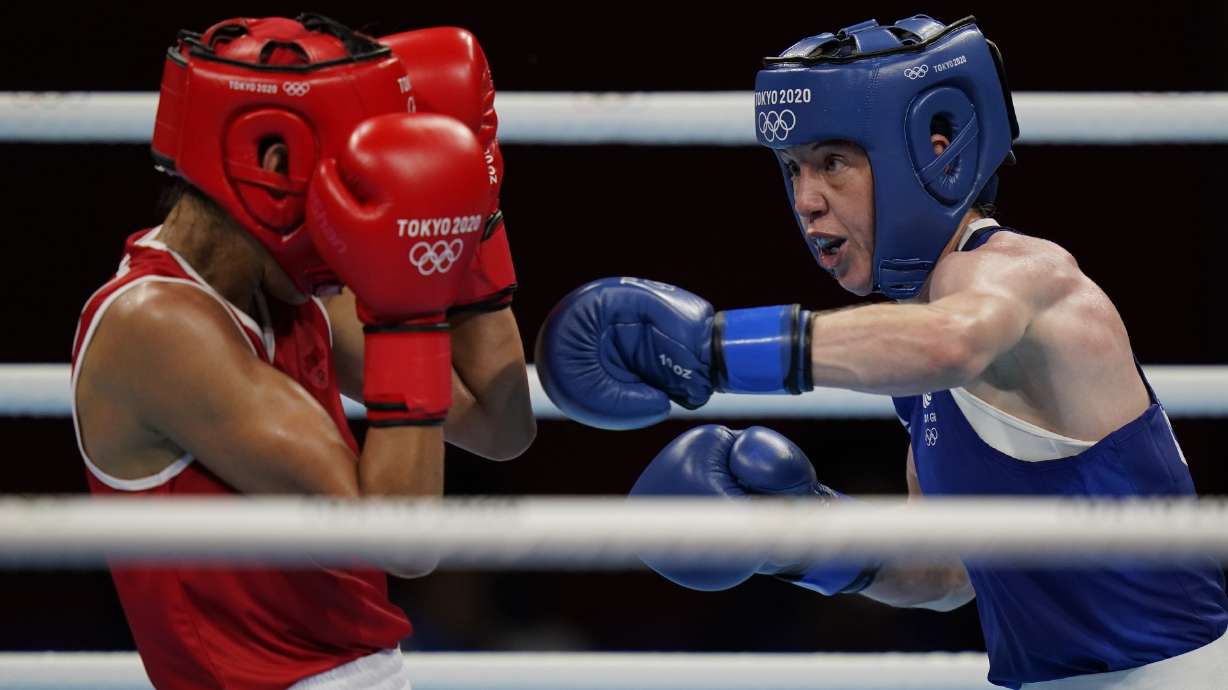 FILE - Morrocco's Rabab Cheddar, left, exchanges punches with Britains' Charley-Sian Davison during their women's flyweight 51-kg boxing match at the 2020 Summer Olympics, Sunday, July 25, 2021, in Tokyo, Japan. Just 12 years after women’s boxing debuted at the Olympics in only three weight classes, half of the boxers in Paris will be women in a field that’s deeper and more talented than ever.