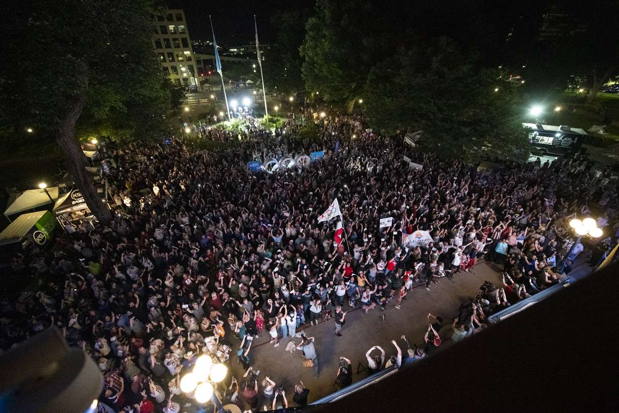 Attendees cheer after the International Olympic Committee awarded the 2034 Winter Olympic Games to the Salt Lake City-Utah Committee during a live watch party held at the Salt Lake City-County Building Wednesday in downtown Salt Lake City.