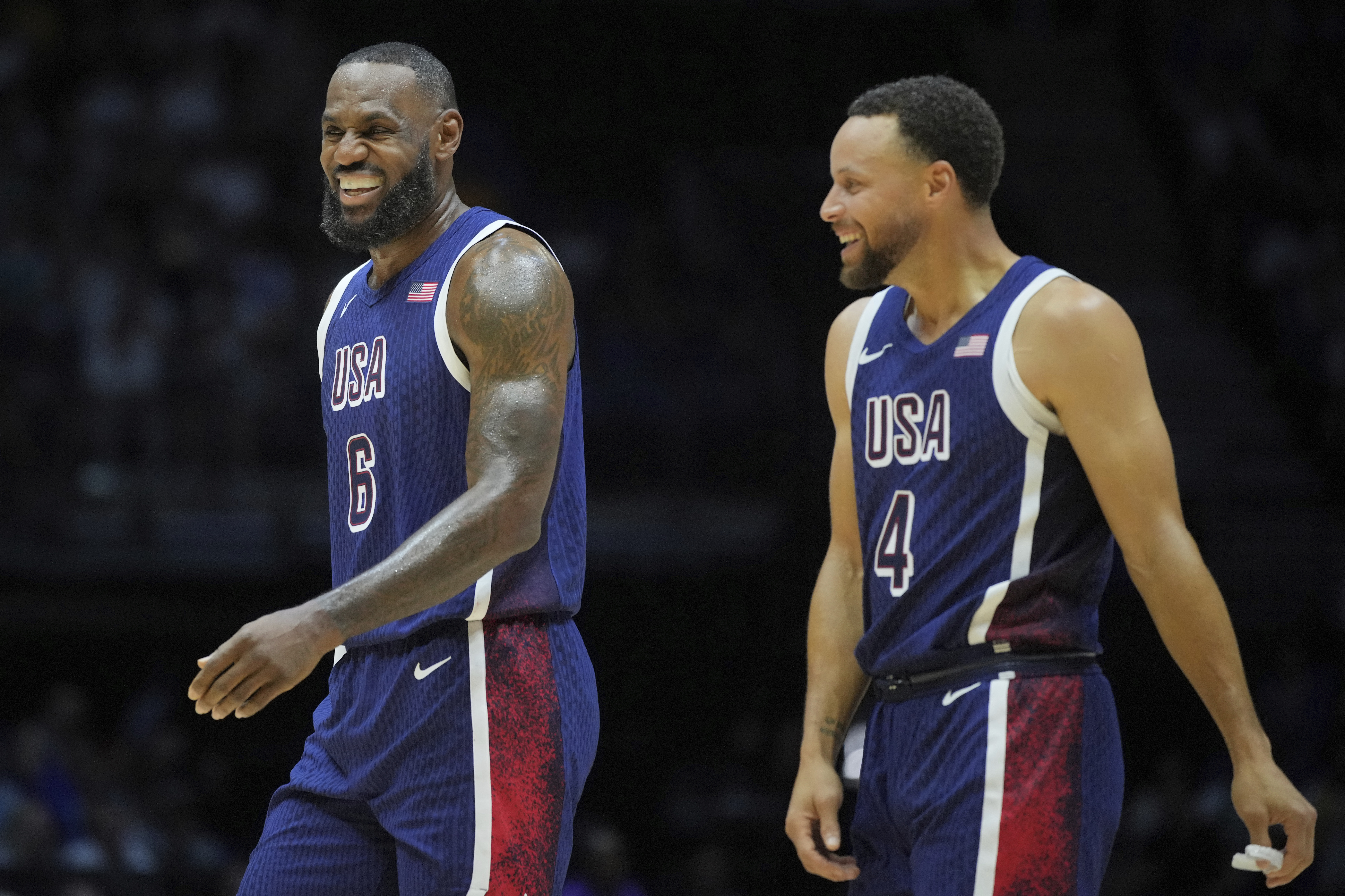 United States' forward LeBron James, left, and teammate United States' guard Stephen Curry smile during an exhibition basketball game between the United States and South Sudan, at the o2 Arena in London, Saturday, July 20, 2024. 