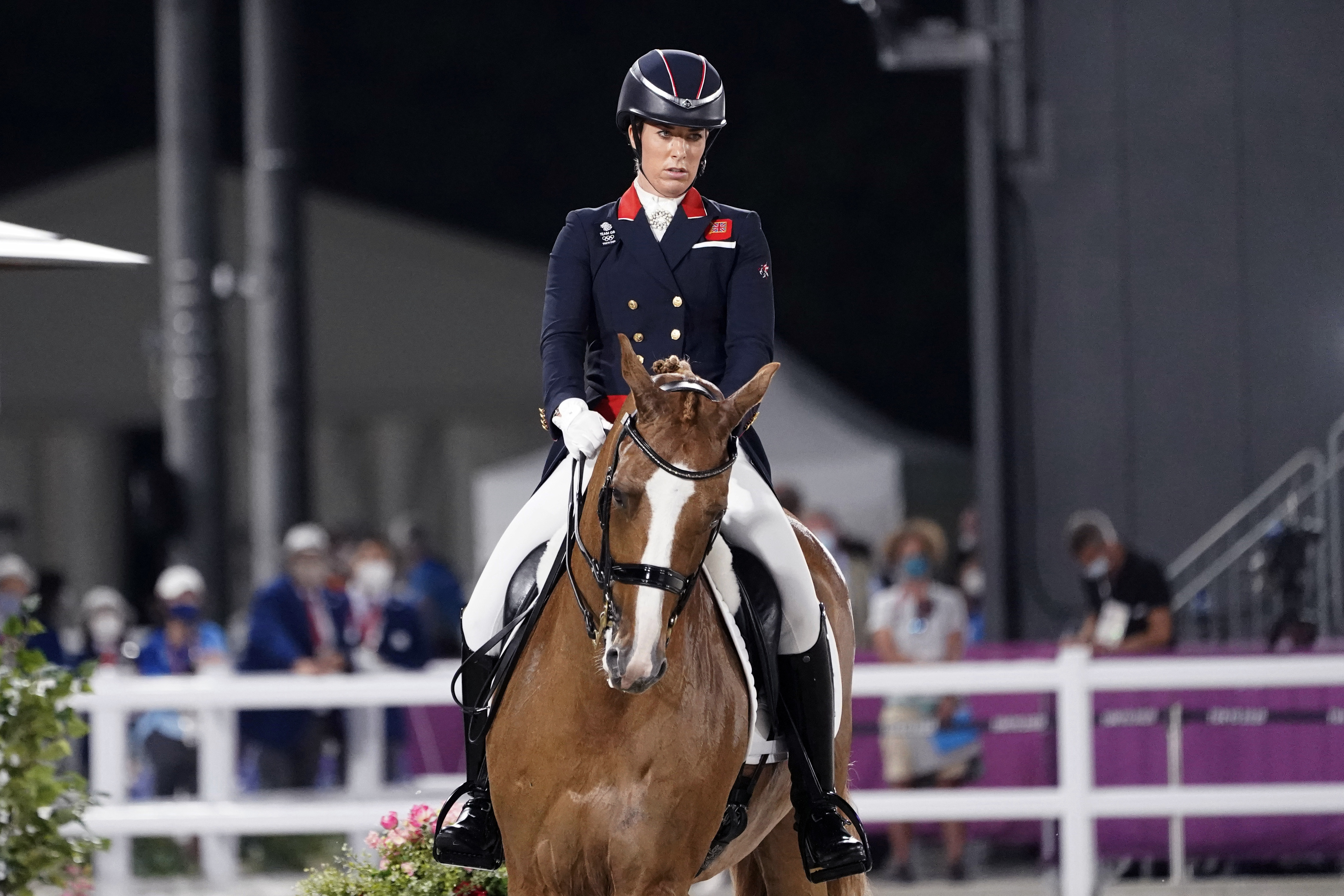 FILE - Britain's Charlotte Dujardin, riding Gio, competes in the equestrian dressage individual final at the 2020 Summer Olympics, Wednesday, July 28, 2021, in Tokyo. Three-time Olympic gold medalist Charlotte Dujardin of Great Britain has withdrawn from the Paris Games after a video emerged that she says shows her behaving inappropriately while coaching other riders. 