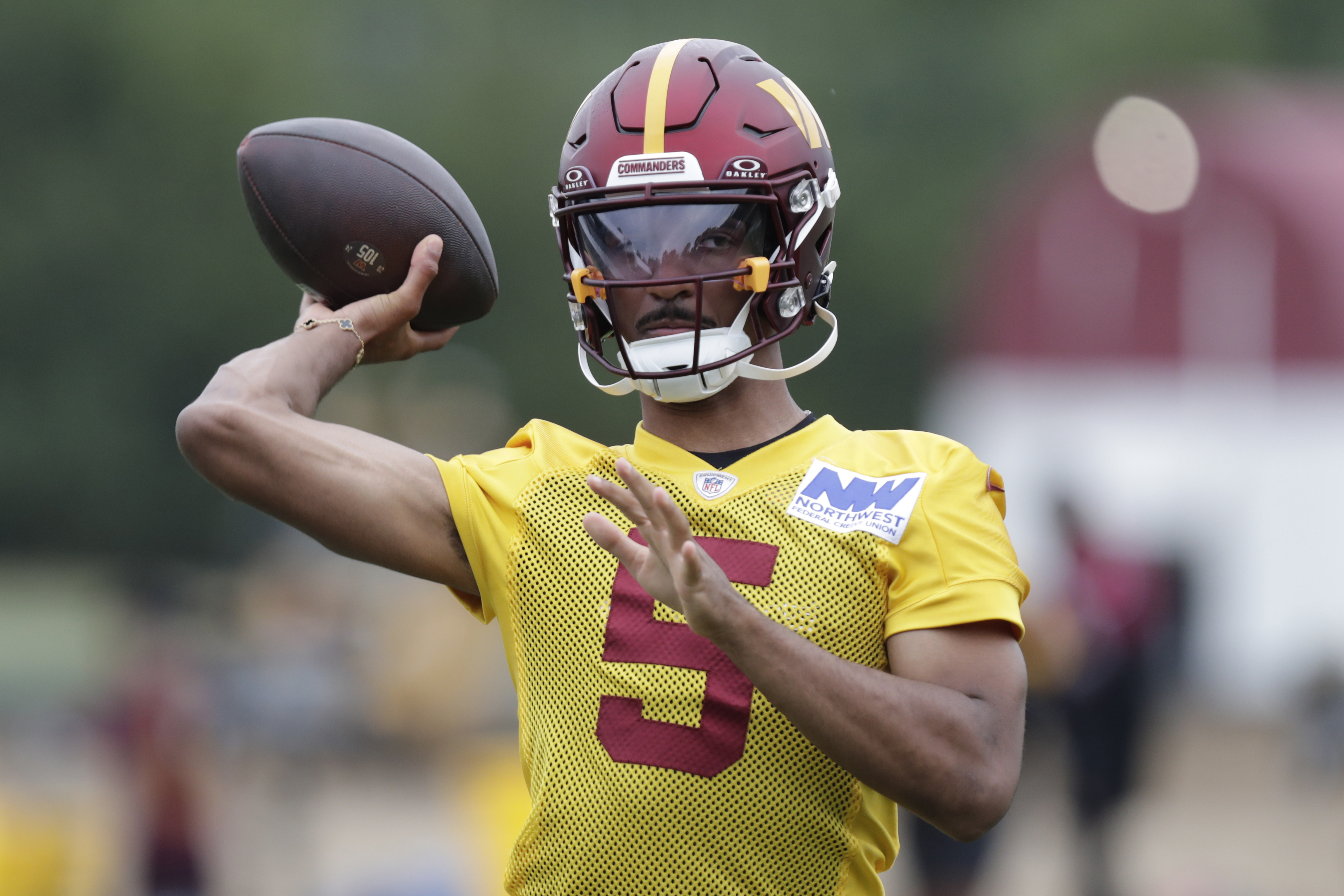 Washington Commanders quarterback Jayden Daniels throws a pass during an NFL football practice at the team's training facility in Ashburn, Va., Wednesday, July 24, 2023. 