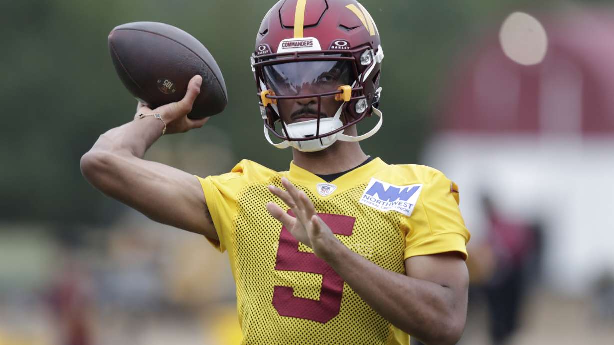 Washington Commanders quarterback Jayden Daniels throws a pass during an NFL football practice at the team's training facility in Ashburn, Va., Wednesday, July 24, 2023.