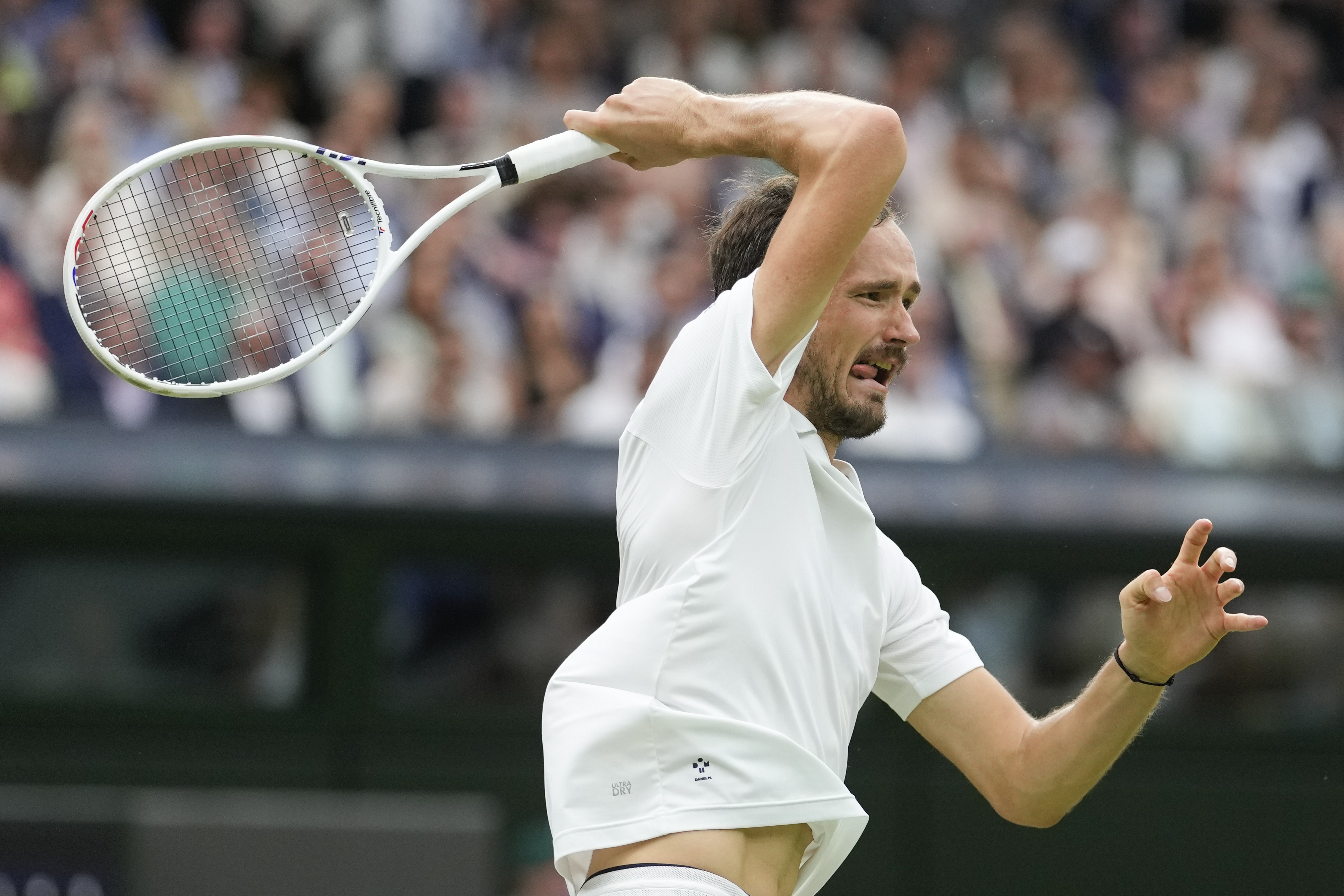 Daniil Medvedev of Russia plays a forehand return to Jannik Sinner of Italy during their quarterfinal match at the Wimbledon tennis championships in London, Tuesday, July 9, 2024.