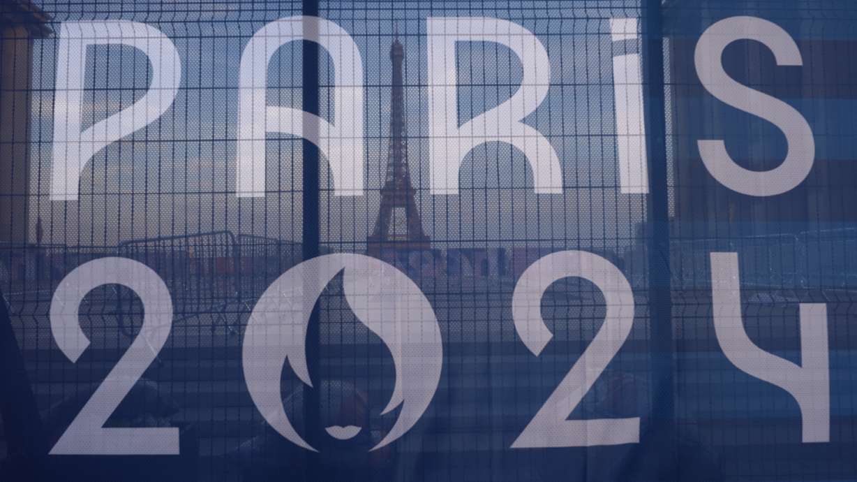 FILE - The Eiffel Tower is seen behind a Paris Olympics canvas, from the Trocadero plaza Thursday, July 18, 2024 in Paris.
