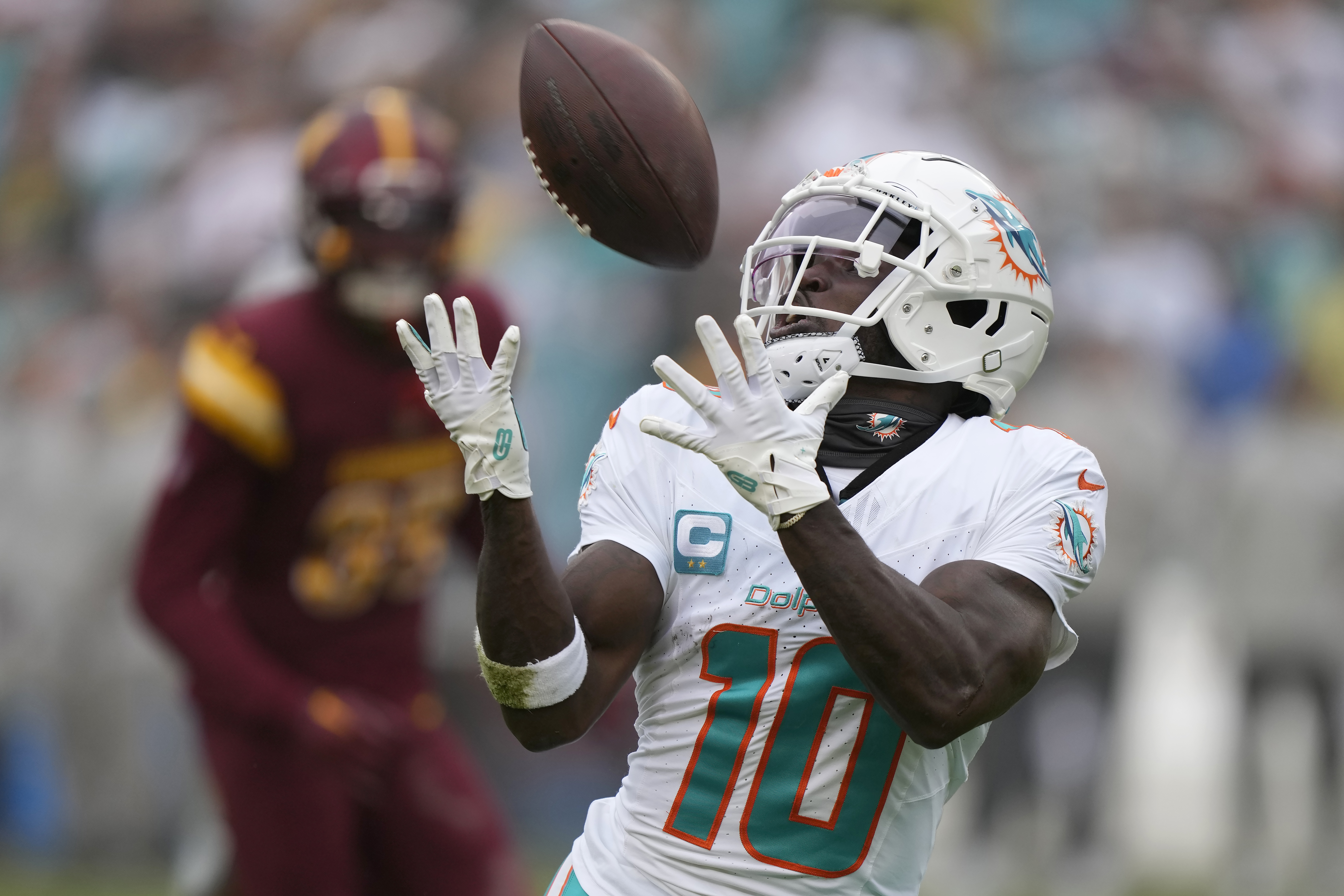 FILE - Miami Dolphins wide receiver Tyreek Hill  catches a touchdown pass during the first half of an NFL football game against the Washington Commanders Sunday, Dec. 3, 2023, in Landover, Md. (AP Photo/Mark Schiefelbein, File(