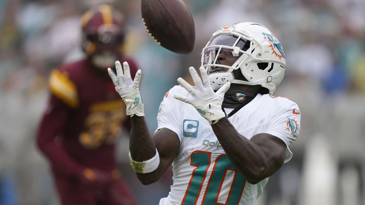 FILE - Miami Dolphins wide receiver Tyreek Hill catches a touchdown pass during the first half of an NFL football game against the Washington Commanders Sunday, Dec. 3, 2023, in Landover, Md. (AP Photo/Mark Schiefelbein, File(