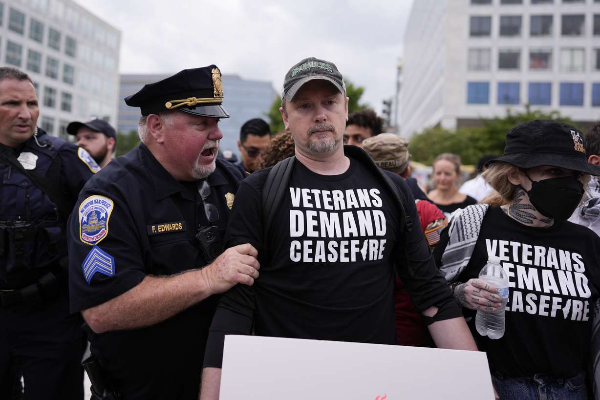 Washington Metropolitan Police clear demonstrators from blocking traffic, Wednesday, in Washington, ahead of a scheduled visit by Israeli Prime Minister Benjamin Netanyahu at the U.S. Capitol.