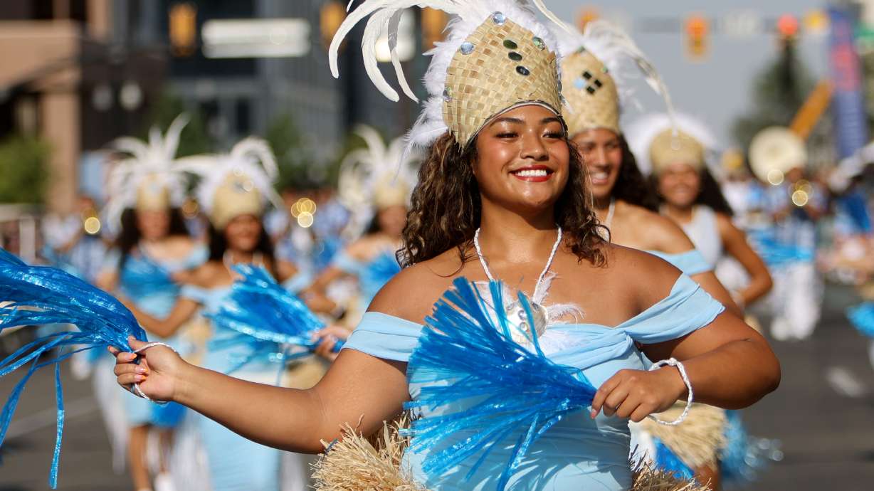 Dancers march with the Liahona Alumni Marching Band in the Days of ’47 Parade in downtown Salt Lake City on Wednesday.