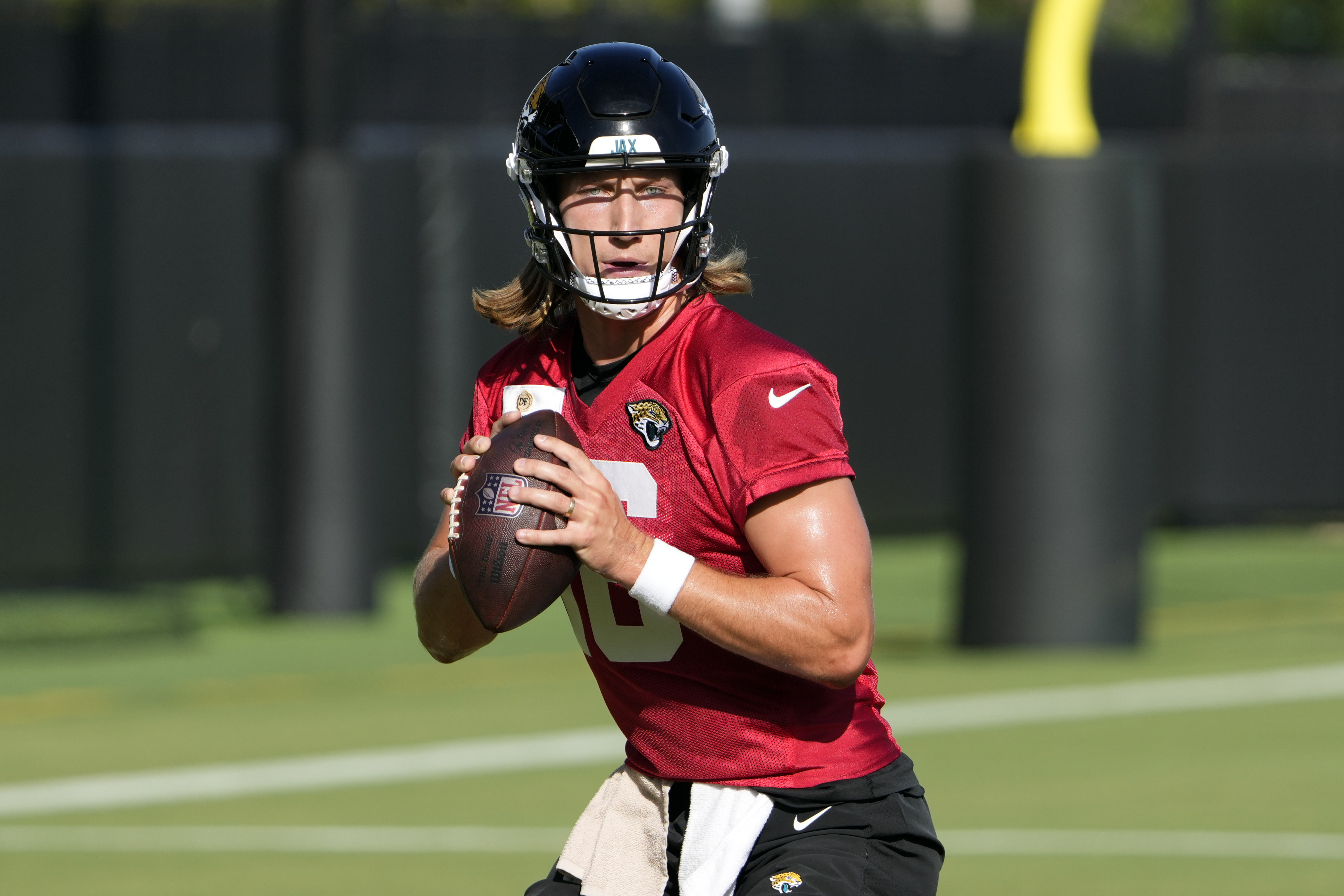 Jacksonville Jaguars quarterback Trevor Lawrence looks for a receiver during the teams NFL football training camp, Wednesday, July 24, 2024, in Jacksonville, Fla.