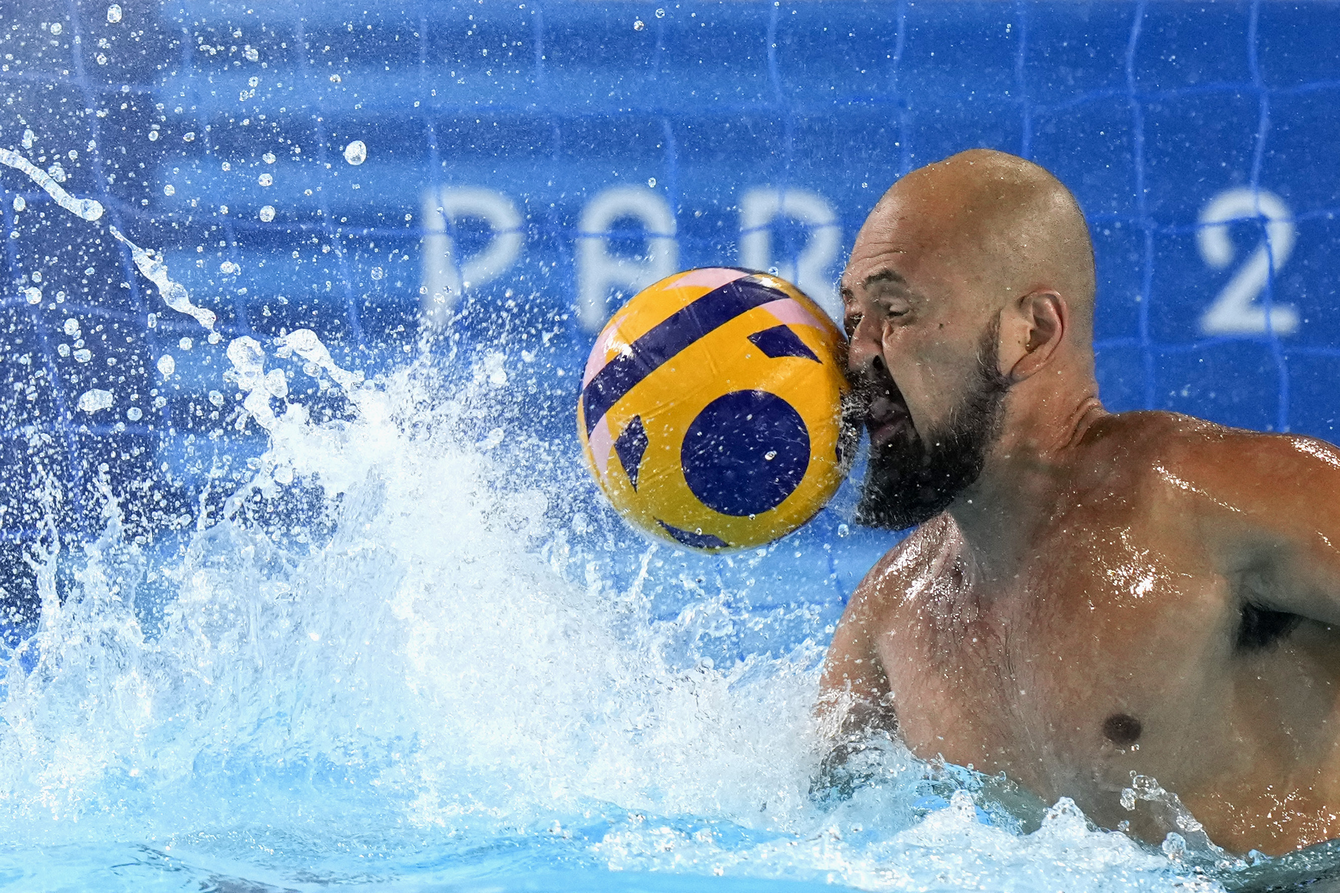Japan's Katsuyuki Tanamura reaches for a shot during a Japan men's water polo team training session at the Olympic Aquatics Centre, ahead of the 2024 Summer Olympics, Tuesday, July 23, 2024, in Saint-Denis, France. 