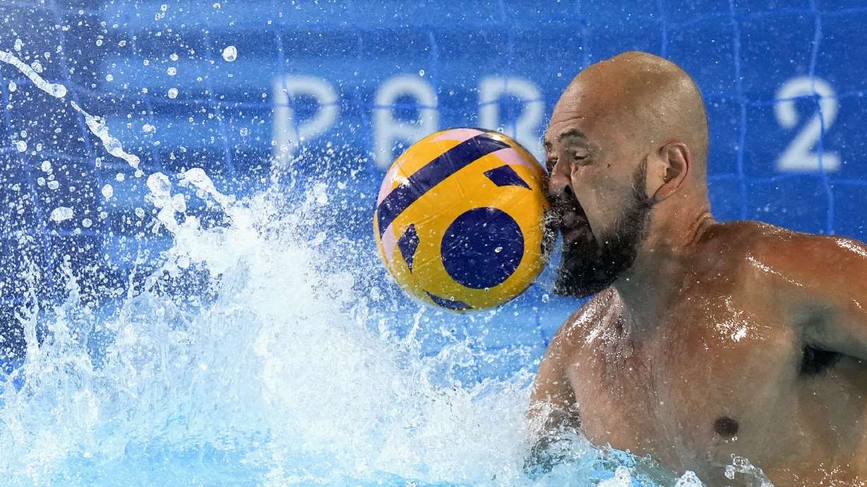 Japan's Katsuyuki Tanamura reaches for a shot during a Japan men's water polo team training session at the Olympic Aquatics Centre, ahead of the 2024 Summer Olympics, Tuesday, July 23, 2024, in Saint-Denis, France.
