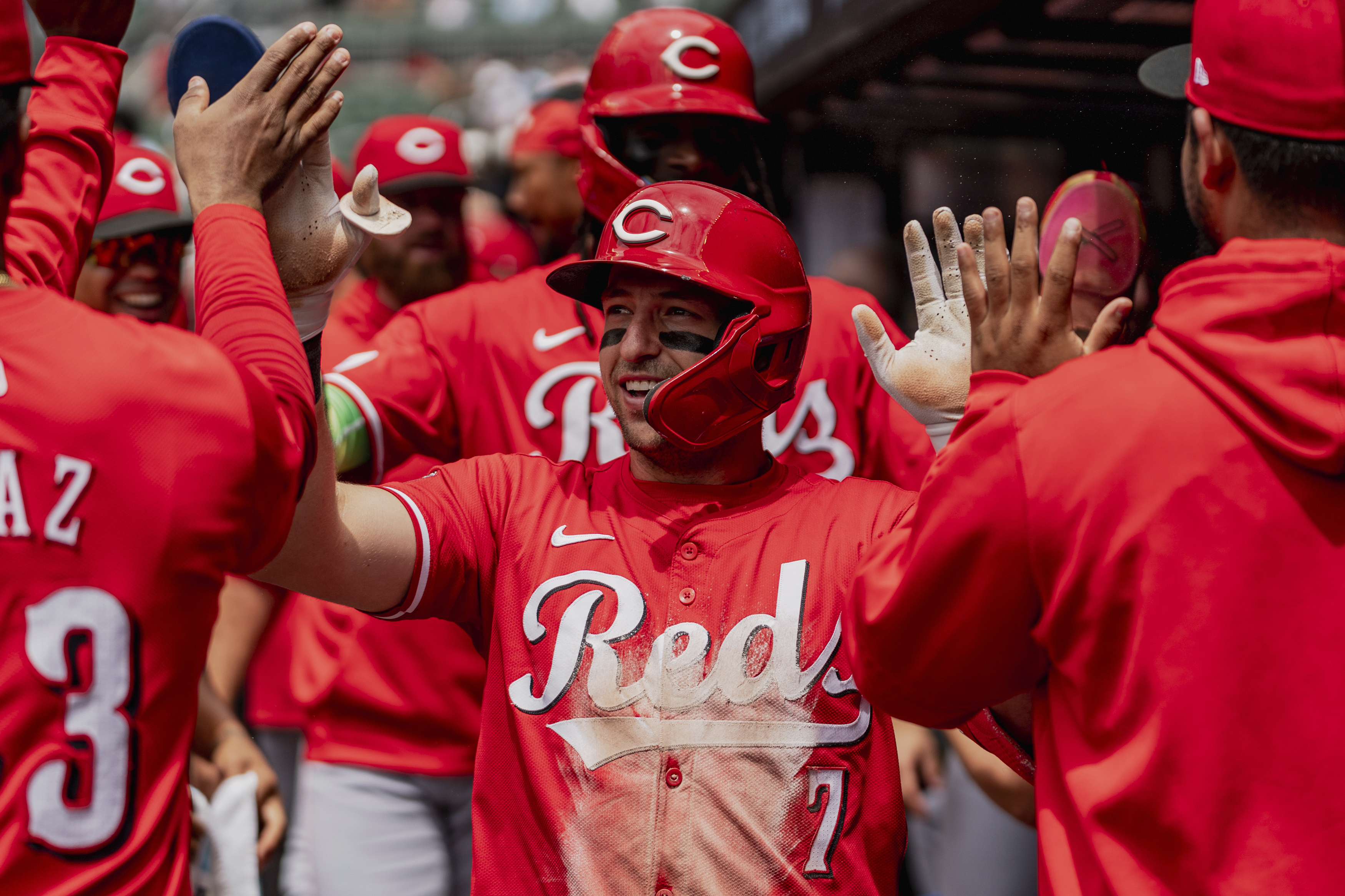 Cincinnati Reds outfielder Spencer Steer (7) celebrates in the dugout after scoring a run in the first inning of the first baseball game of a doubleheader against the Atlanta Braves, Wednesday, July 24, 2024, in Atlanta. 