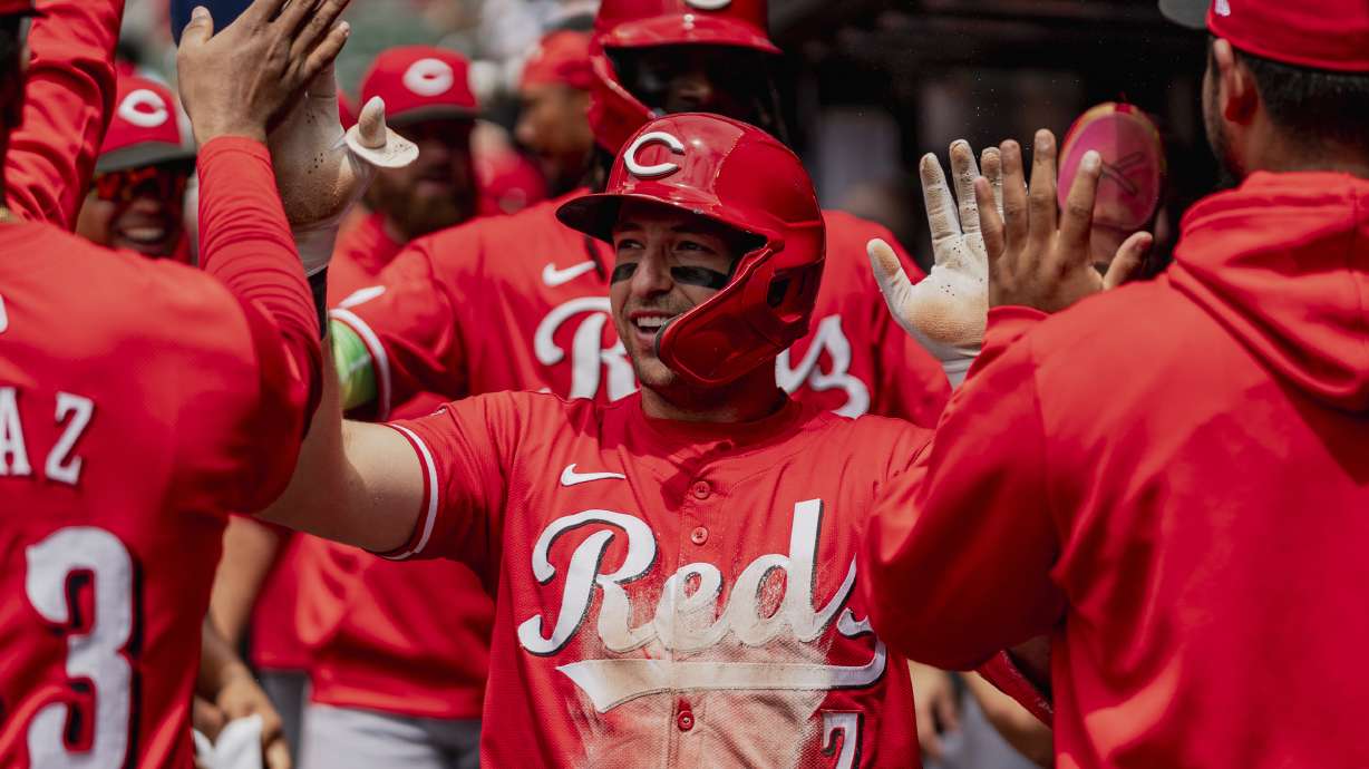 Cincinnati Reds outfielder Spencer Steer (7) celebrates in the dugout after scoring a run in the first inning of the first baseball game of a doubleheader against the Atlanta Braves, Wednesday, July 24, 2024, in Atlanta.