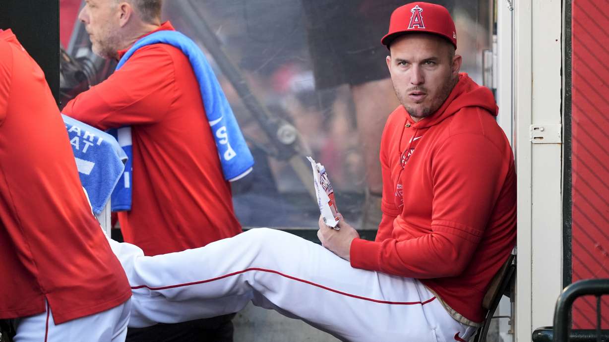 Los Angeles Angels center fielder Mike Trout sits in the dugout during the first inning of the team's baseball game against the Oakland Athletics, Tuesday, June 25, 2024, in Anaheim, Calif.