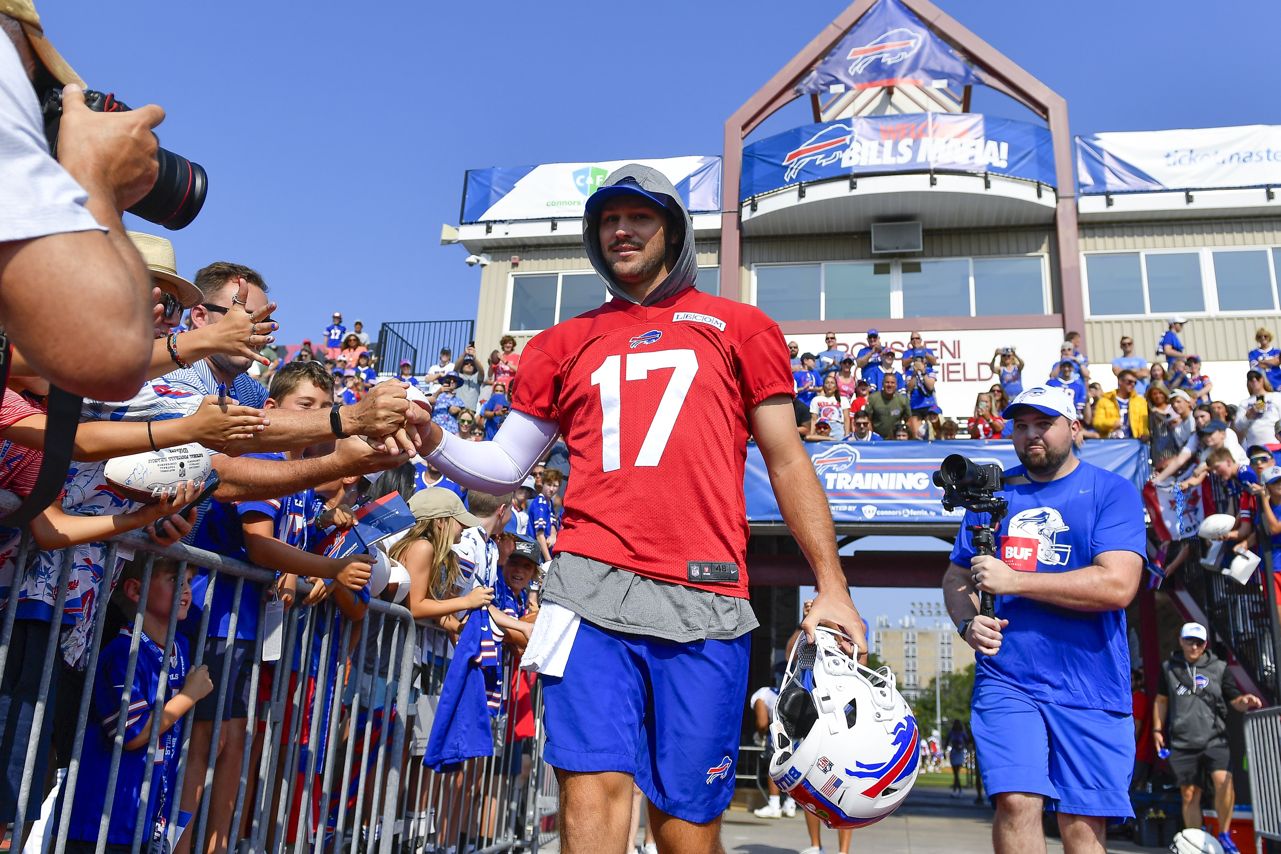 Quarterback Josh Allen (17) greets fans as he walks to the field during an NFL football training camp practice in Pittsford, N.Y., Wednesday, July 24, 2024. 