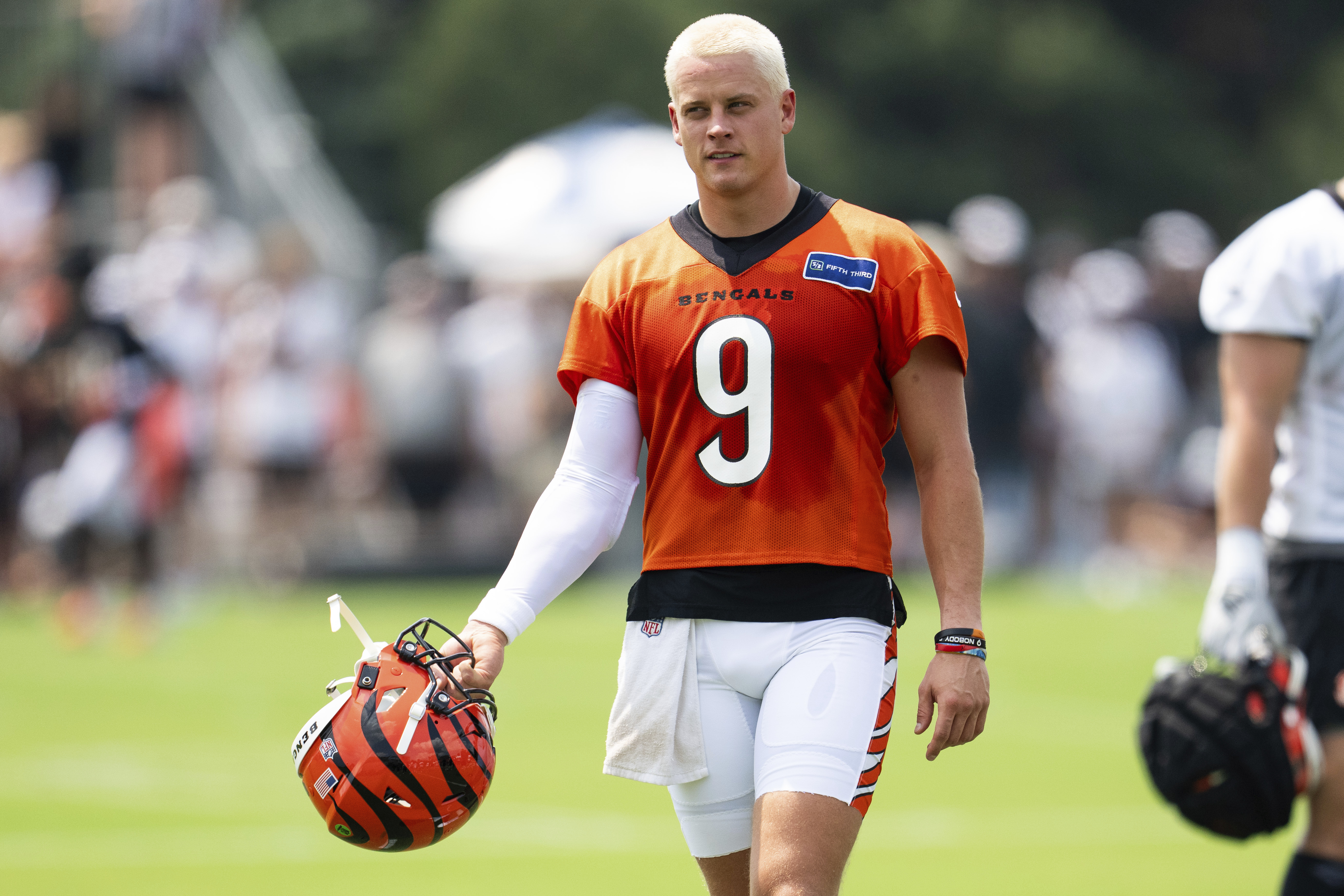 Cincinnati Bengals quarterback Joe Burrow (9) takes off his helmet during a break during the NFL football team's training camp on Wednesday, July 24, 2024, in Cincinnati. 
